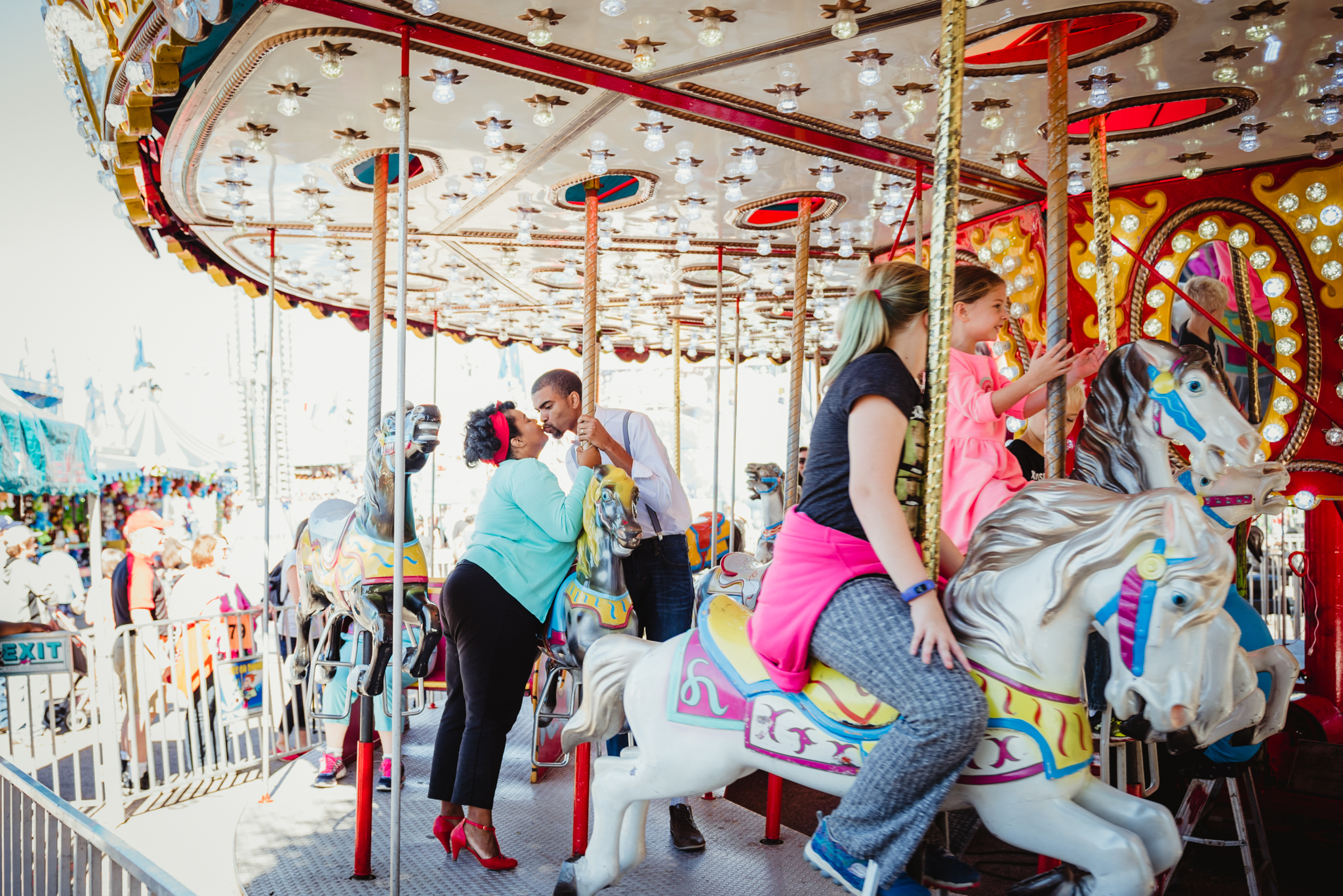 stealing-a-kiss-on-the-carousel-at-the-NC-State-fair.jpg
