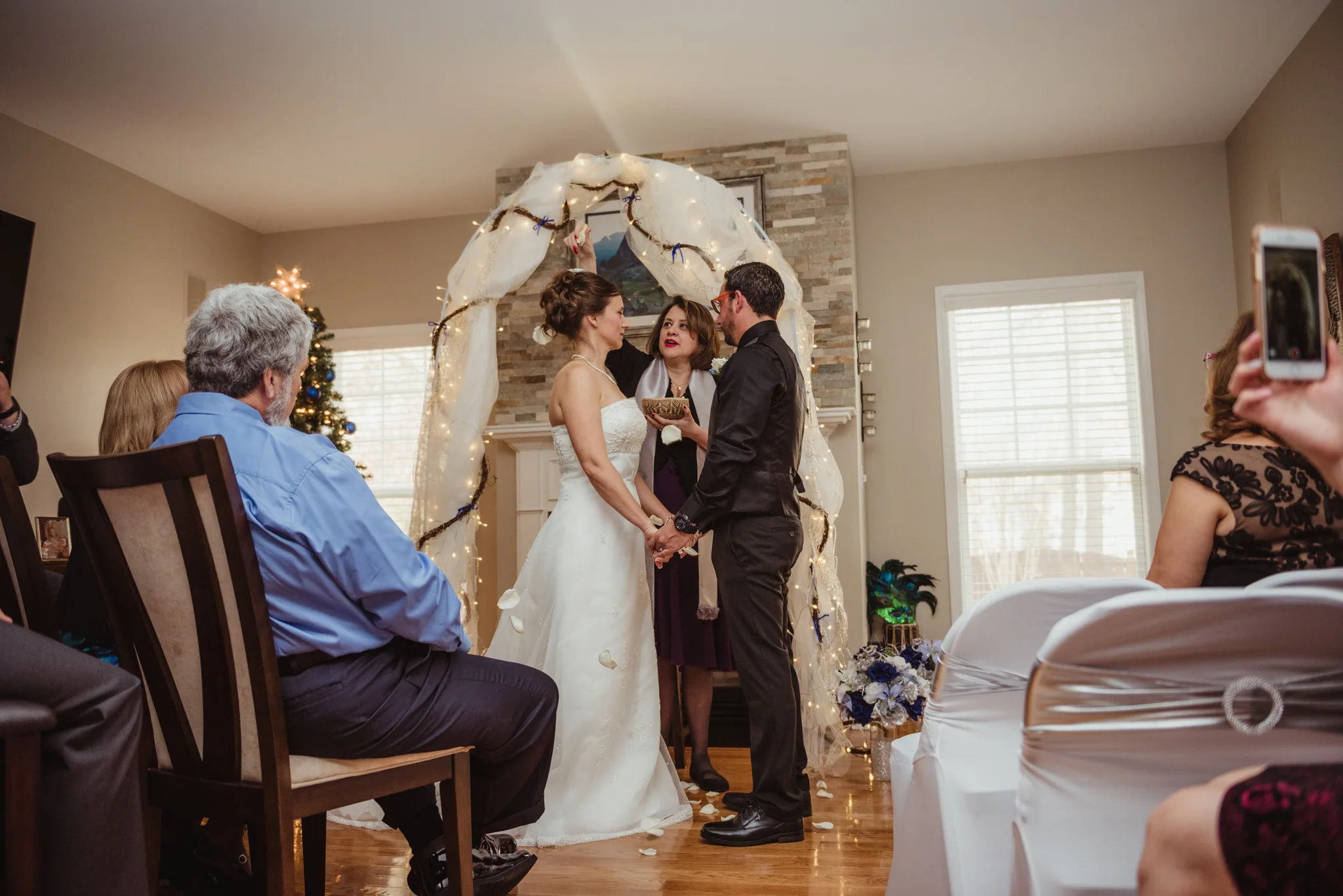 the-bride-and-groom-are-blessed-with-rose-petals-at-their-intimate-home-wedding-in-Raleigh.jpg