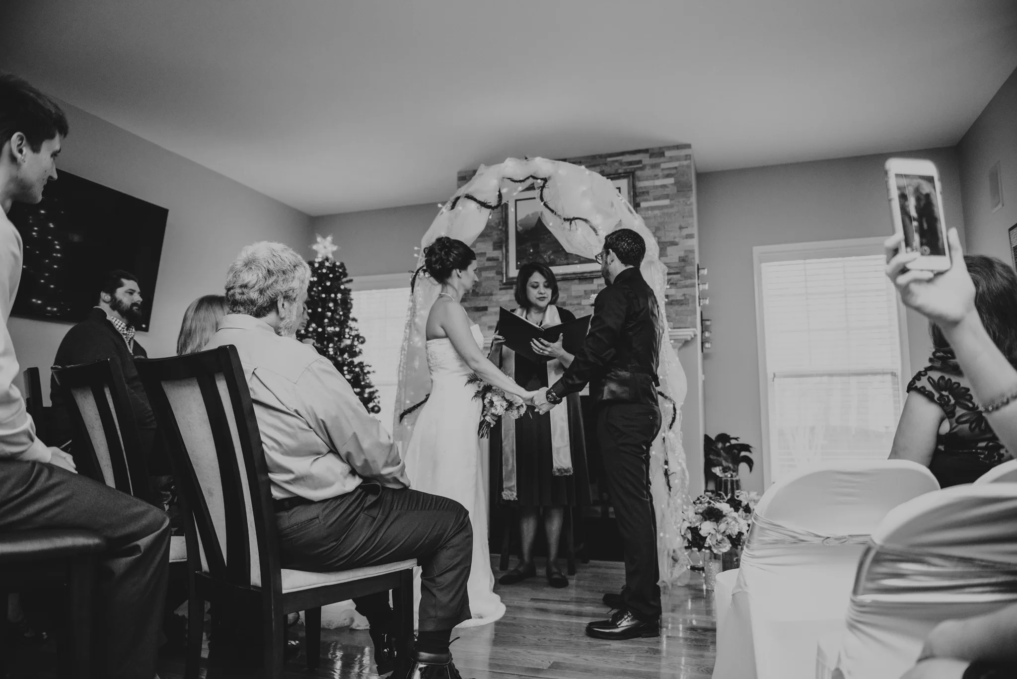 their-families-and-friends-watch-the-bride-and-groom-exchange-vows-at-their-intimate-home-wedding-in-Raleigh.jpg