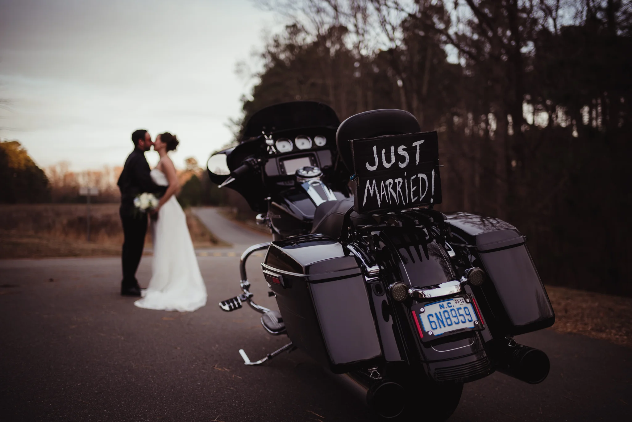 the-bride-and-groom-pose-near-their-motorcycle-after-getting-married-in-raleigh.jpg
