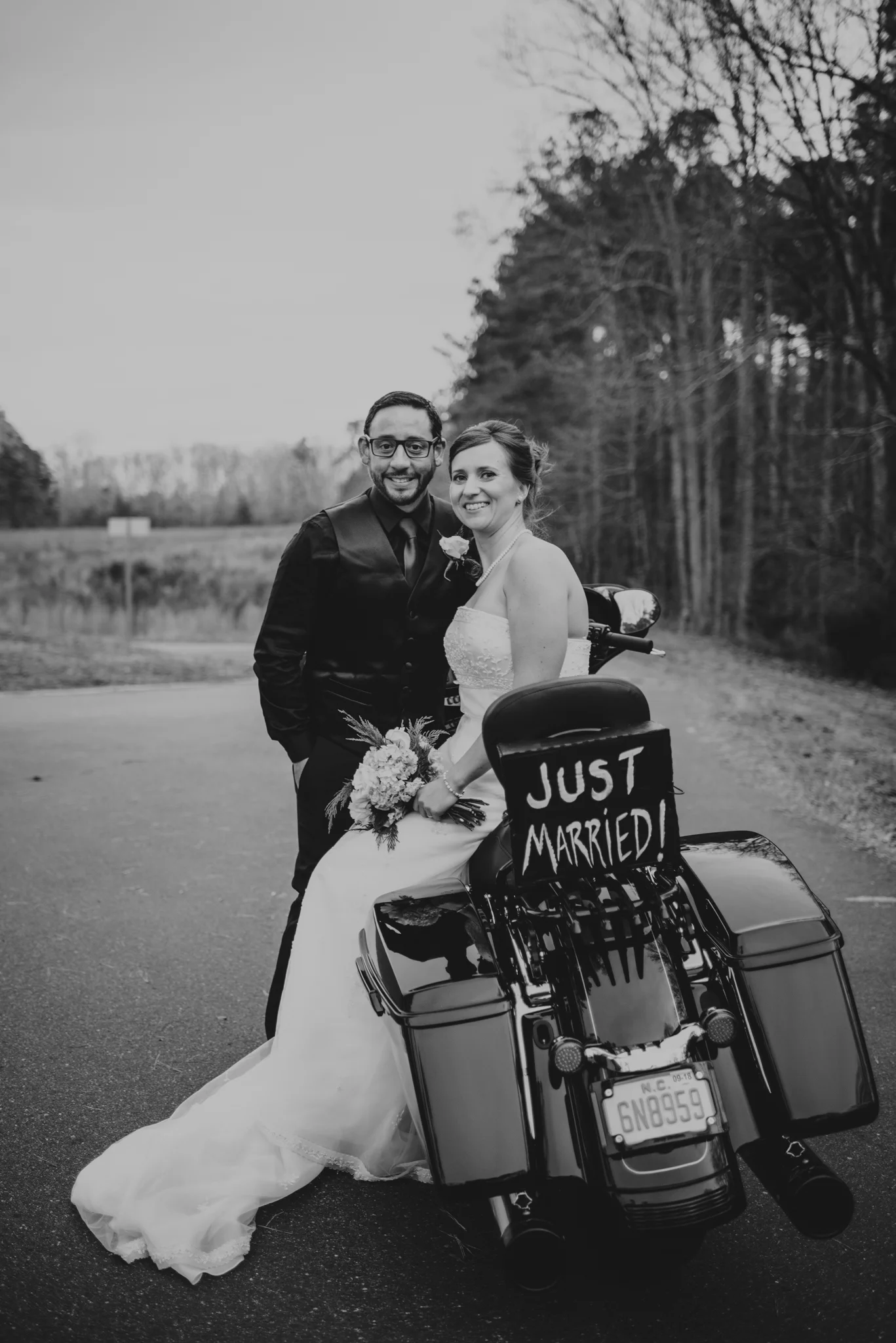 the-bride-and-groom-pose-on-their-bike-after-getting-married-at-an-intimate-home-ceremony-in-raleigh.jpg