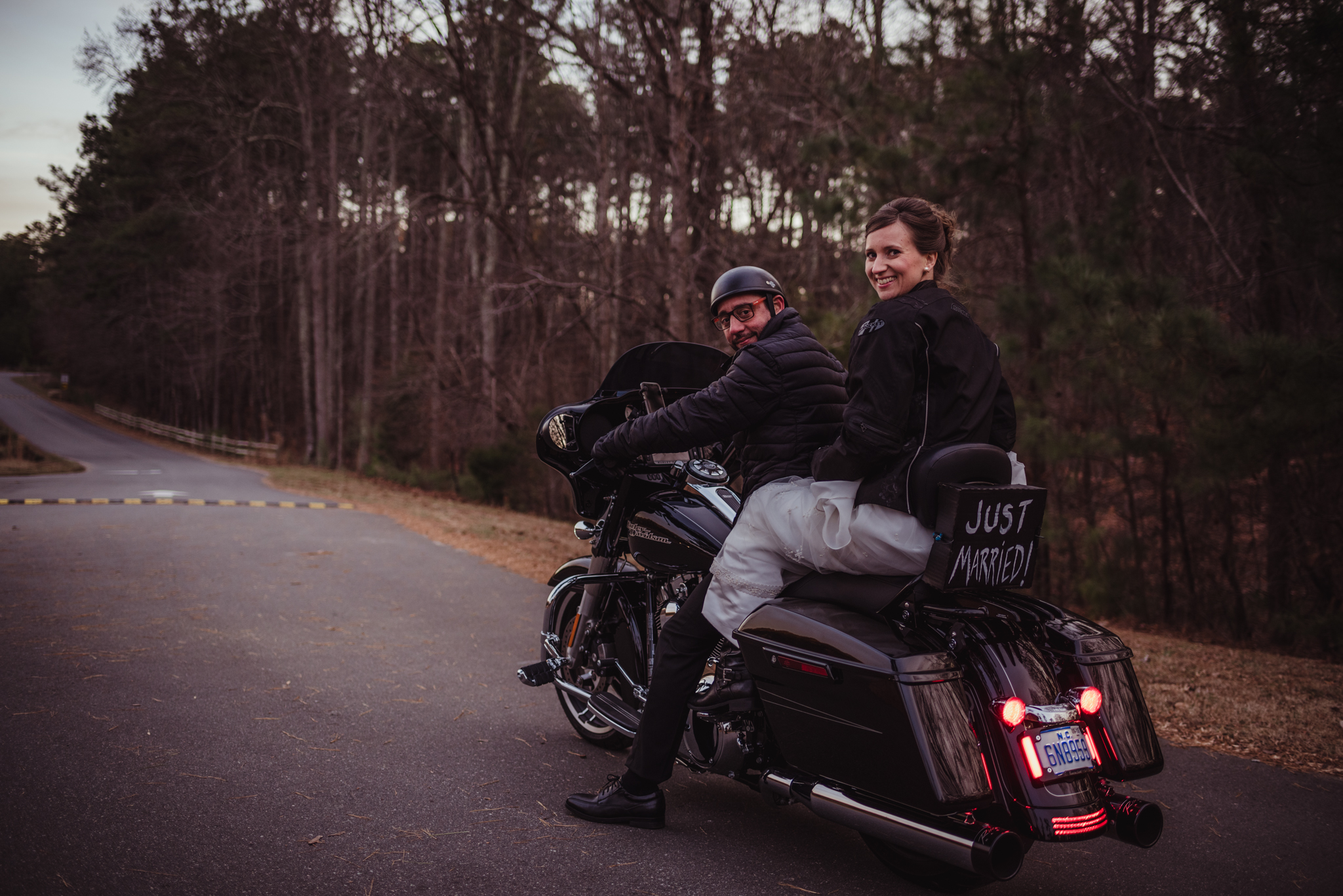 the-bride-and-groom-get-set-to-ride-off-on-their-motorcycle-after-getting-married-in-raleigh.jpg