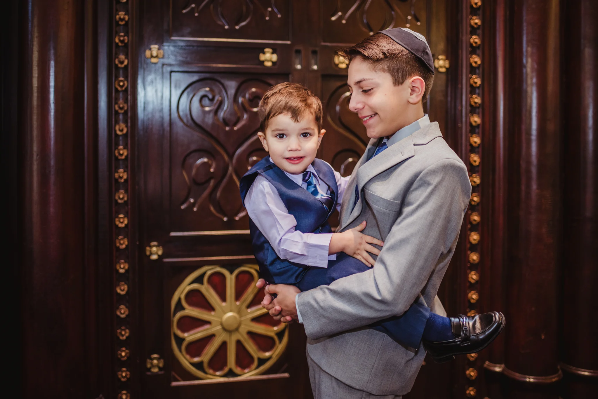 The bar mitzvah boy poses in front of the ark with his younger brother at Temple Beth Or in Raleigh.