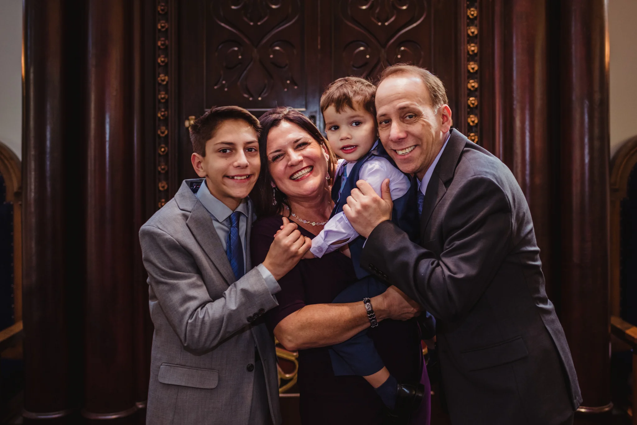 The family poses with their bar mitzvah boy at the ark at Temple Beth Or in Raleigh.