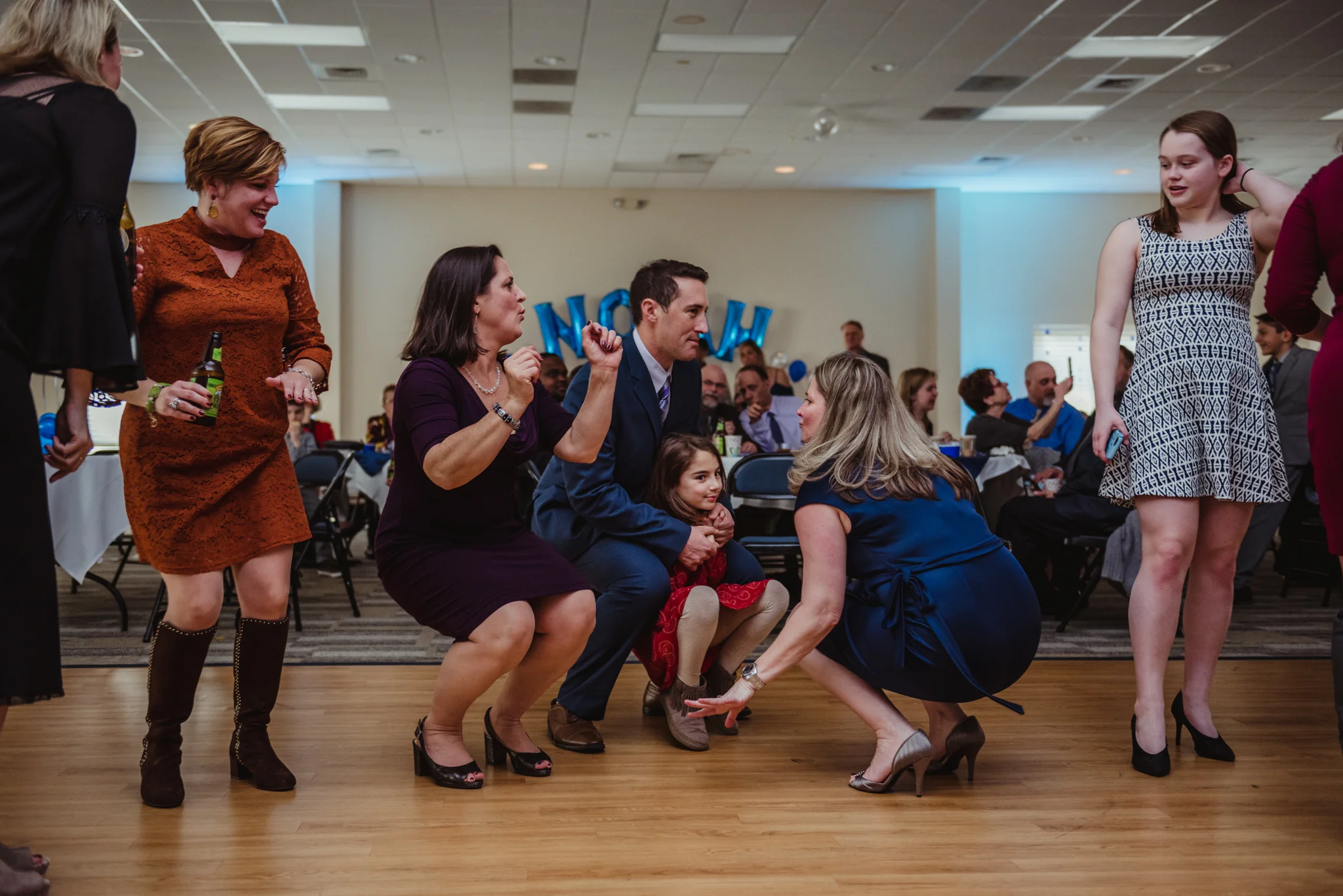 Family and friends dance down low during the bar mitzvah reception at Temple Beth Or in Raleigh.