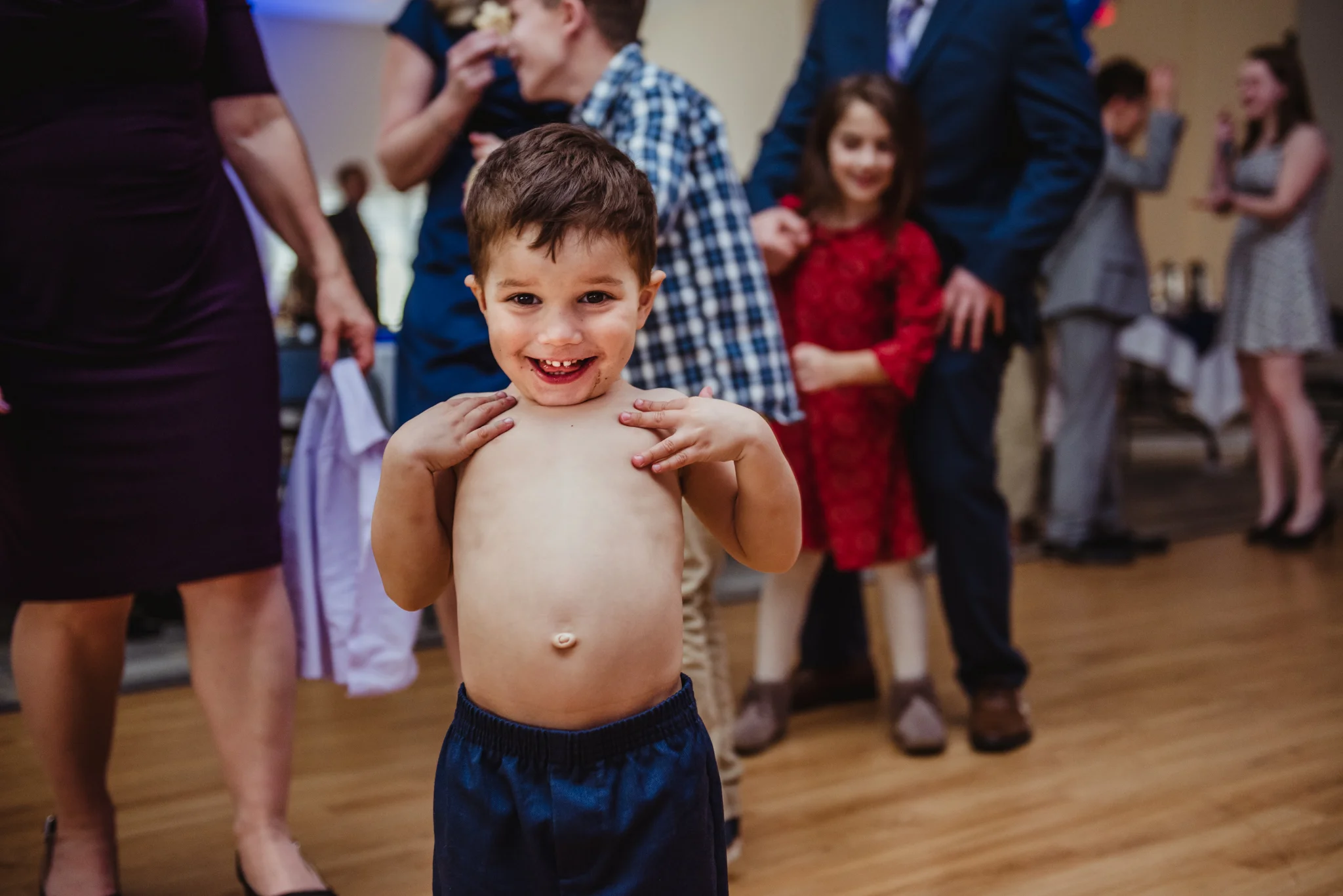 The four year old decided to take his shirt off and proudly show his belly button to the camera at the mitzvah reception.