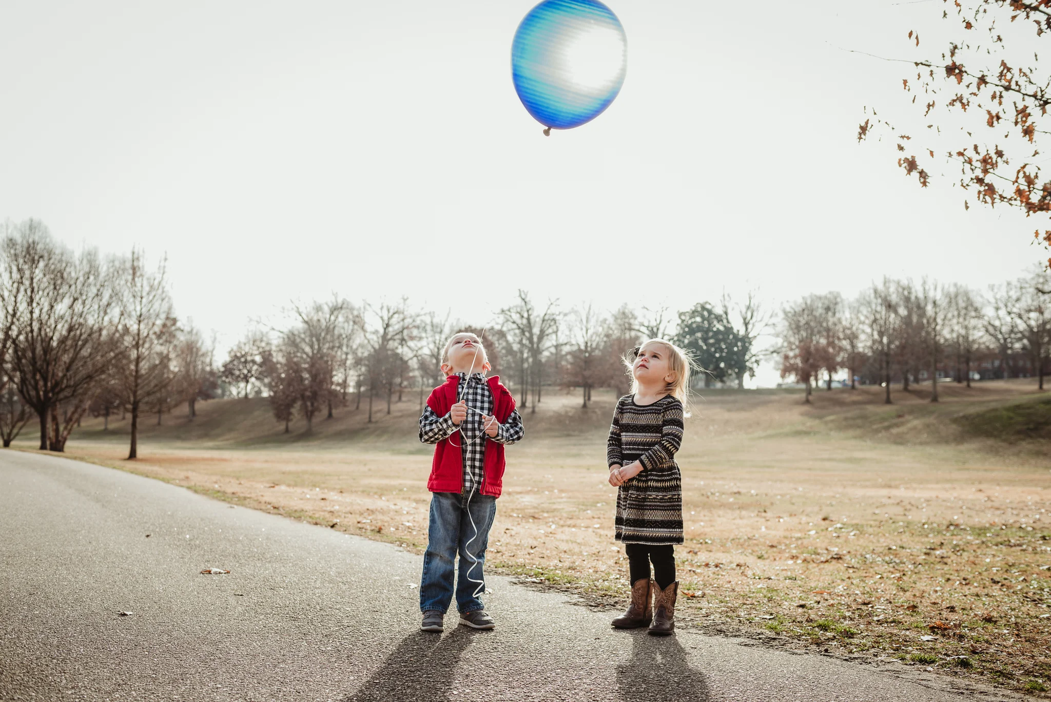 "We love you baby Wyatt" the three year old twins say as they hold onto the blue balloon, brought in his memory.