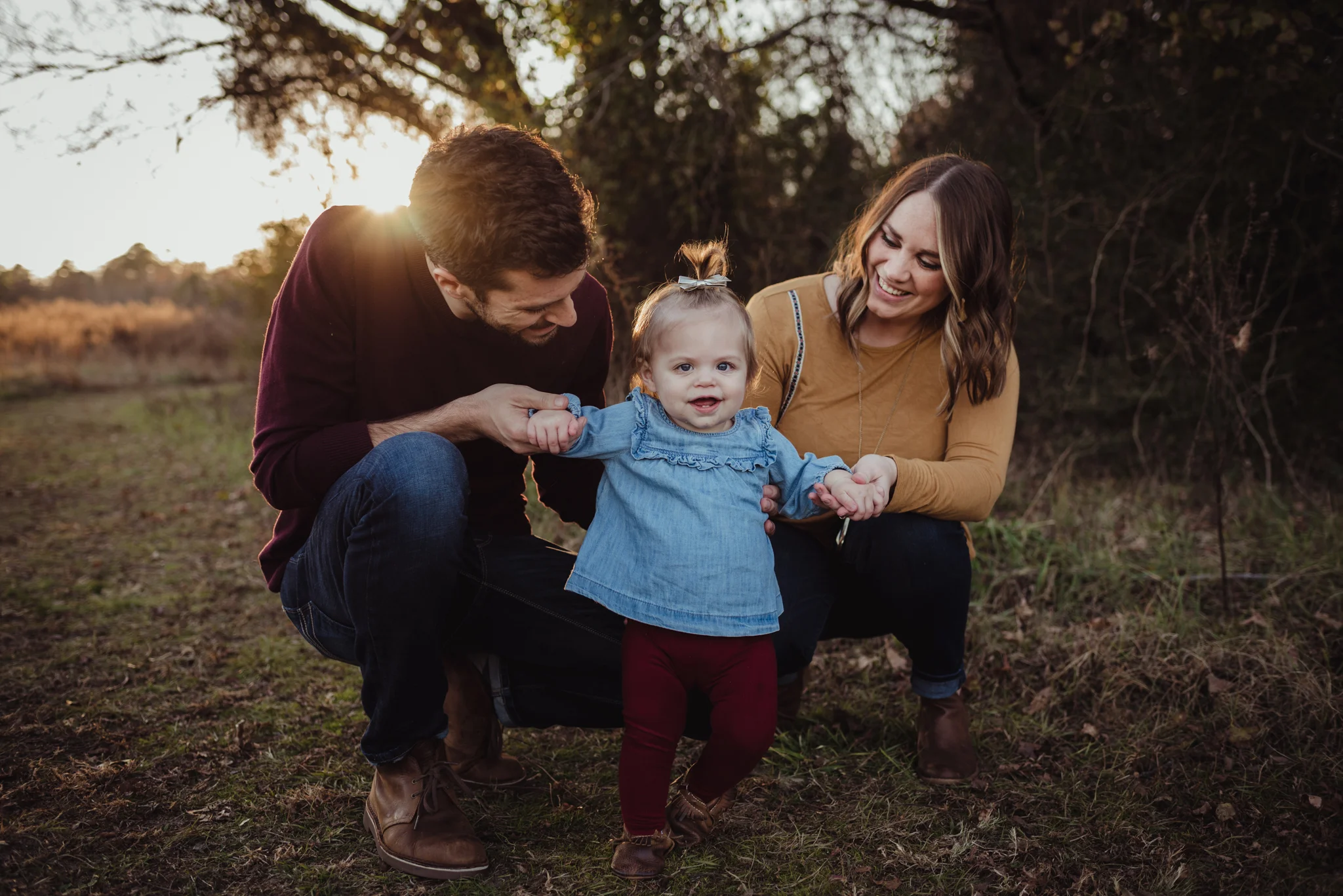This young family of three poses with their young daughter at sunset during their family session with Rose Trail Images in Wake Forest, NC.