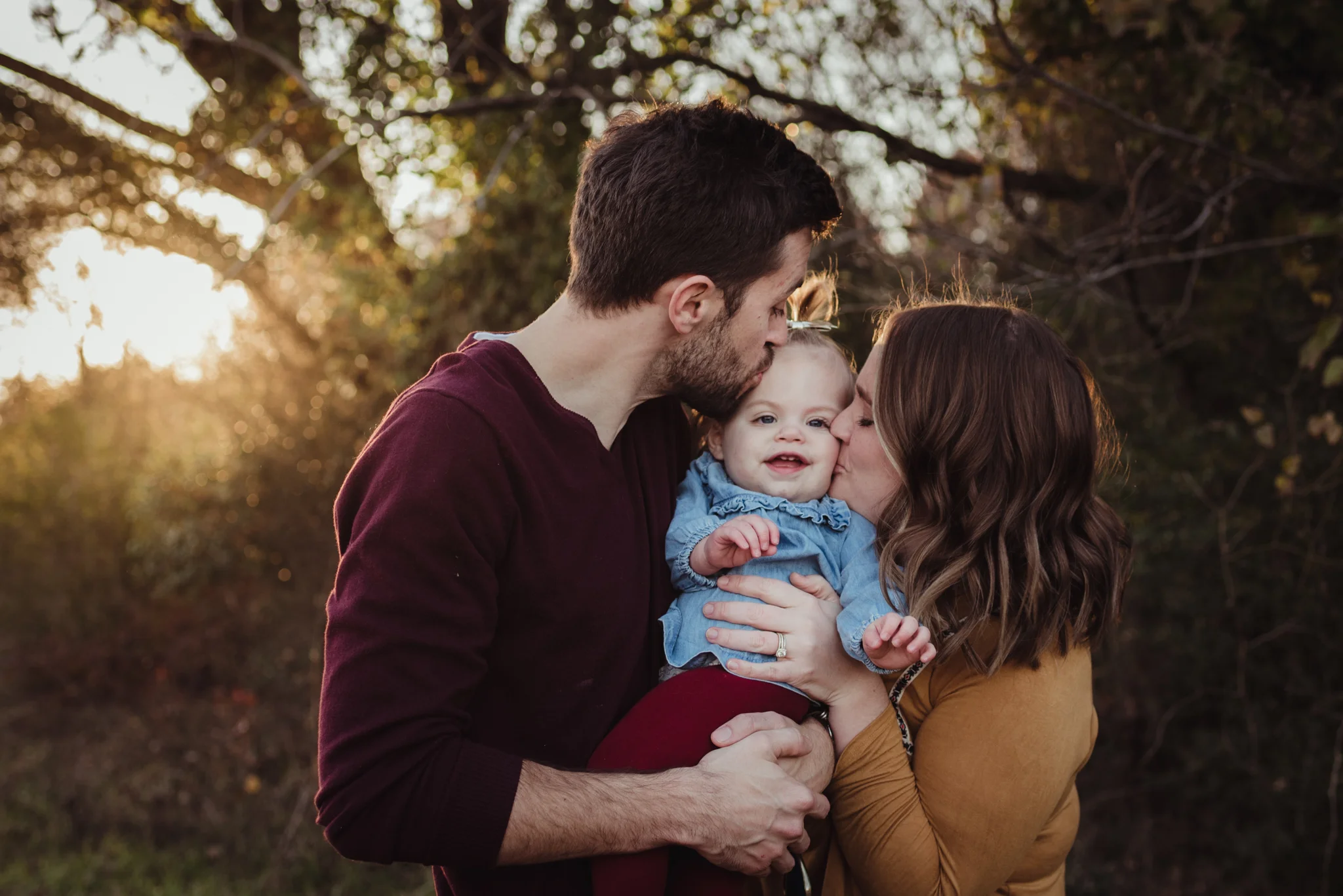 This young family of three kisses their young daughter at sunset during their family session with Rose Trail Images in Wake Forest, NC.