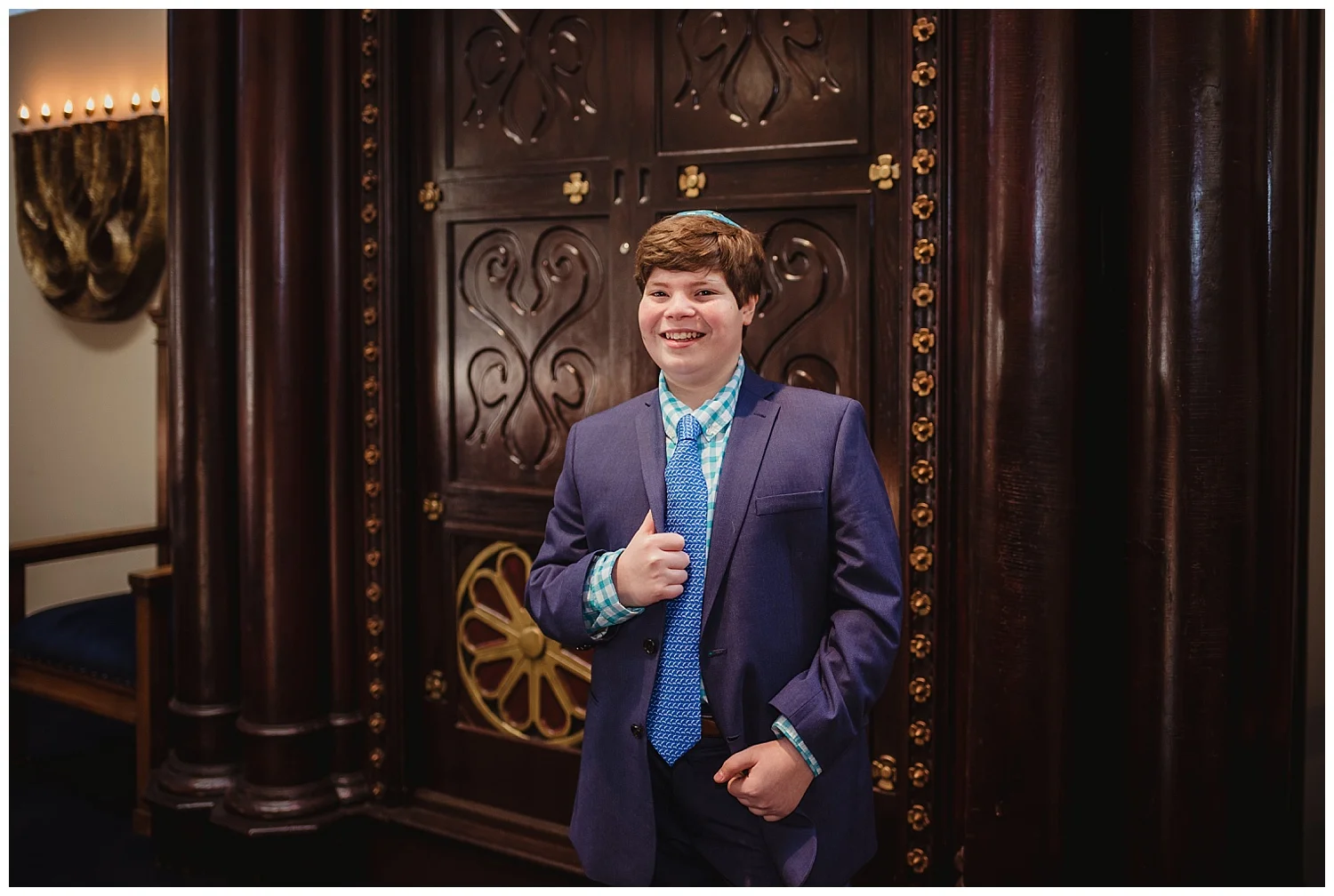 The Bar Mitzvah boy stands on the bema in front of the ark at Temple Beth Or in Raleigh, NC for Rose Trail Images.