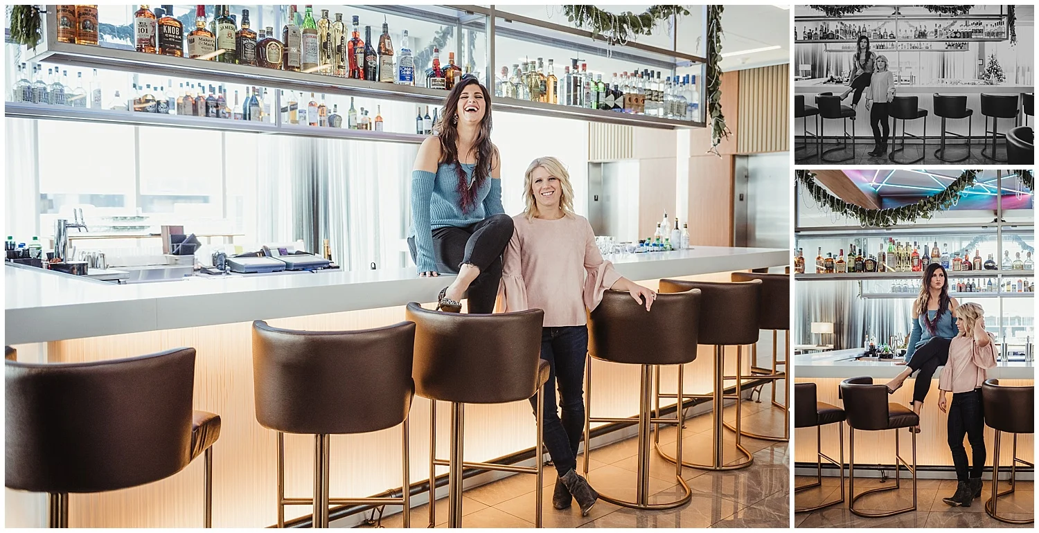 Sarah and Liz from Metro's Other Woman have a good laugh while posing for branding photos on the bar with Rose Trail Images at Level7 Rooftop Bar in Raleigh, NC.