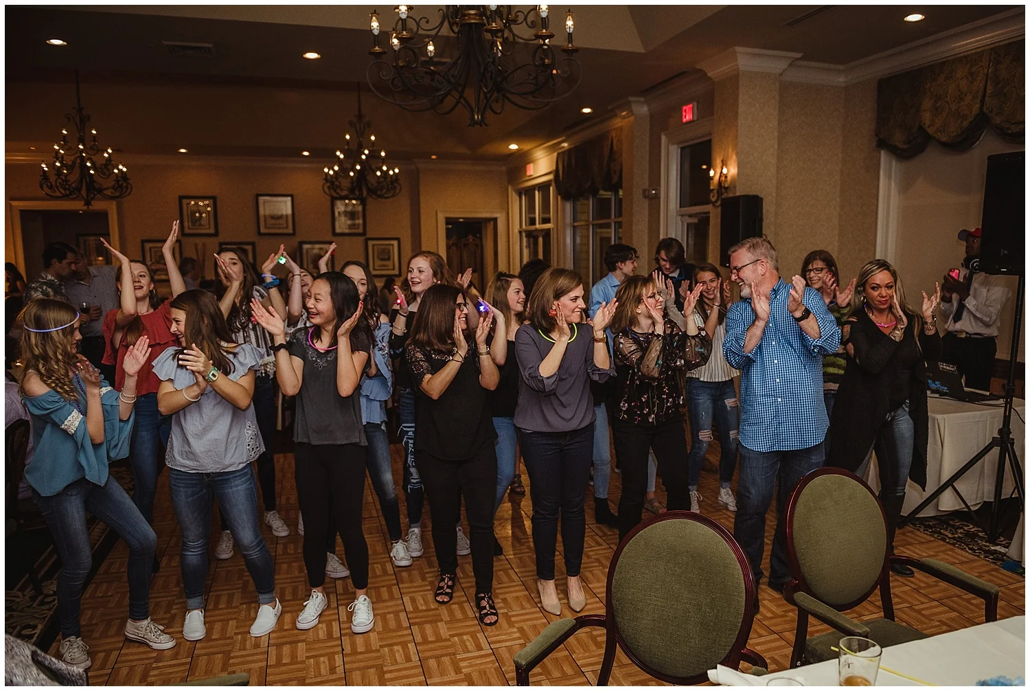 Guests dance and clap along during the mitzvah reception party with Rose Trail Images at the Brier Creek Country Club in Raleigh, NC.
