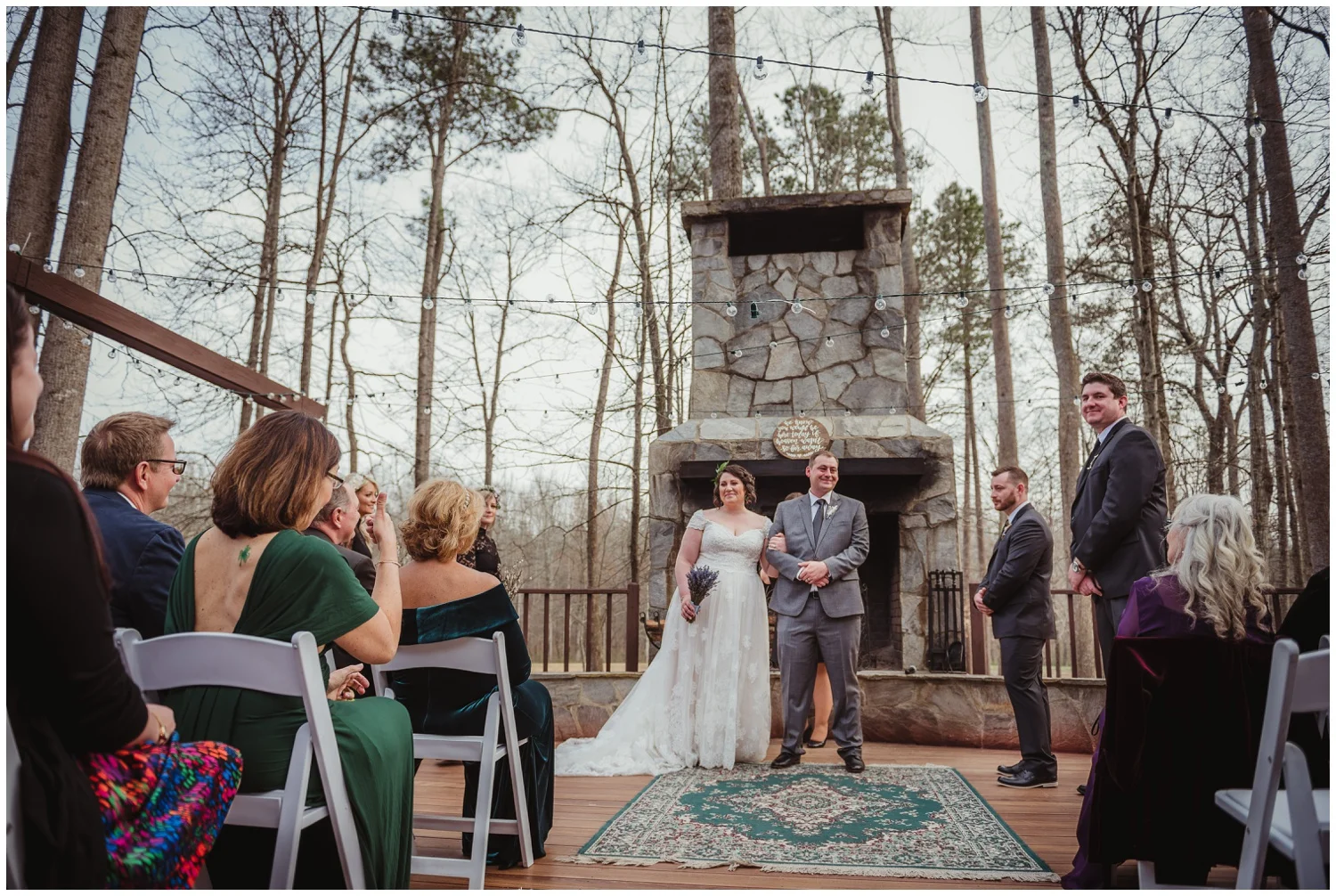 After the bride and groom exchange vows on their wedding day, they stop to stare at their family and friends at the Barn at Valhalla in Chapel Hill, taken by Rose Trail Images.