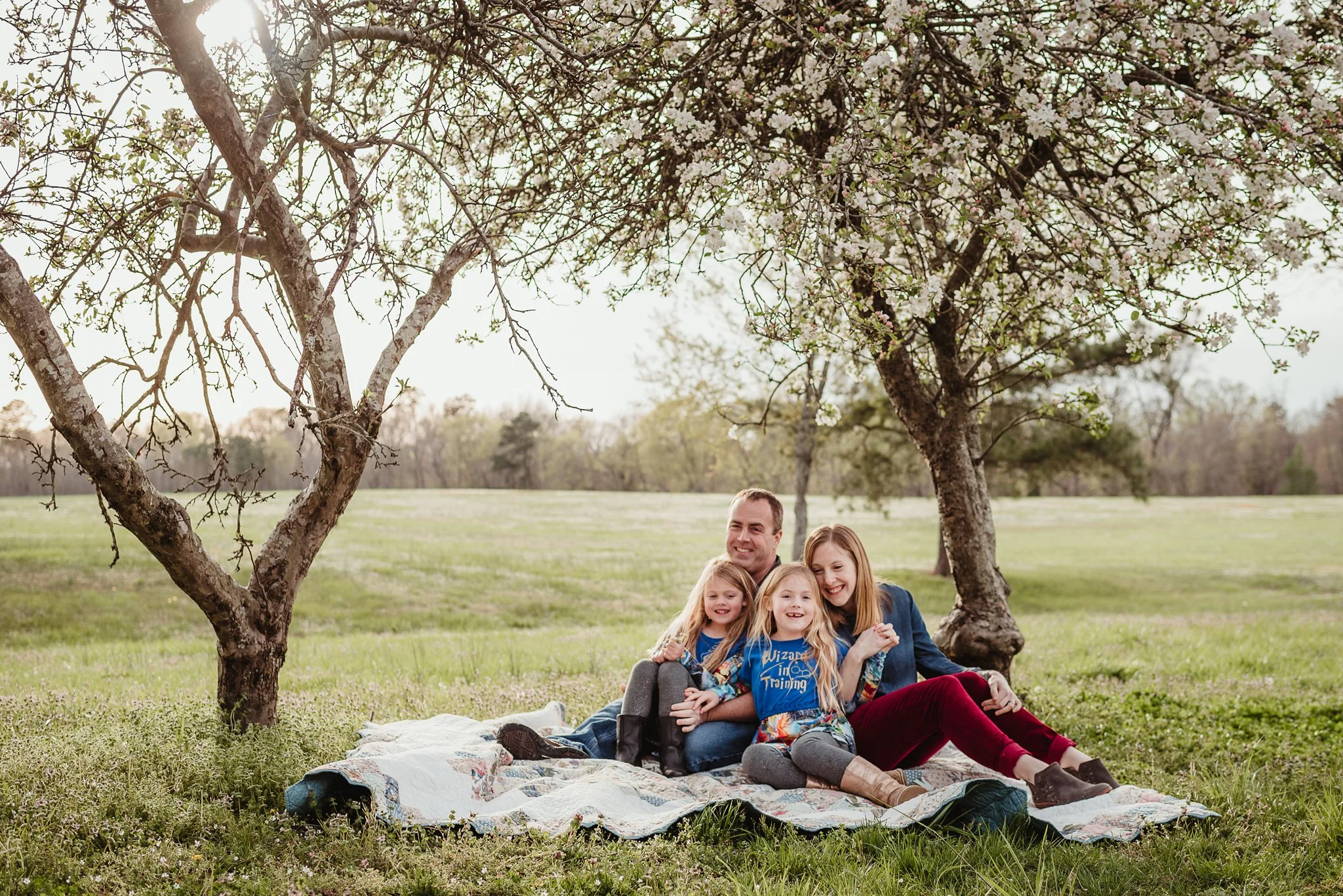 This family of four sat on their quilt and posed for Rose Trail Images during their family photo session in Wake Forest, North Carolina.