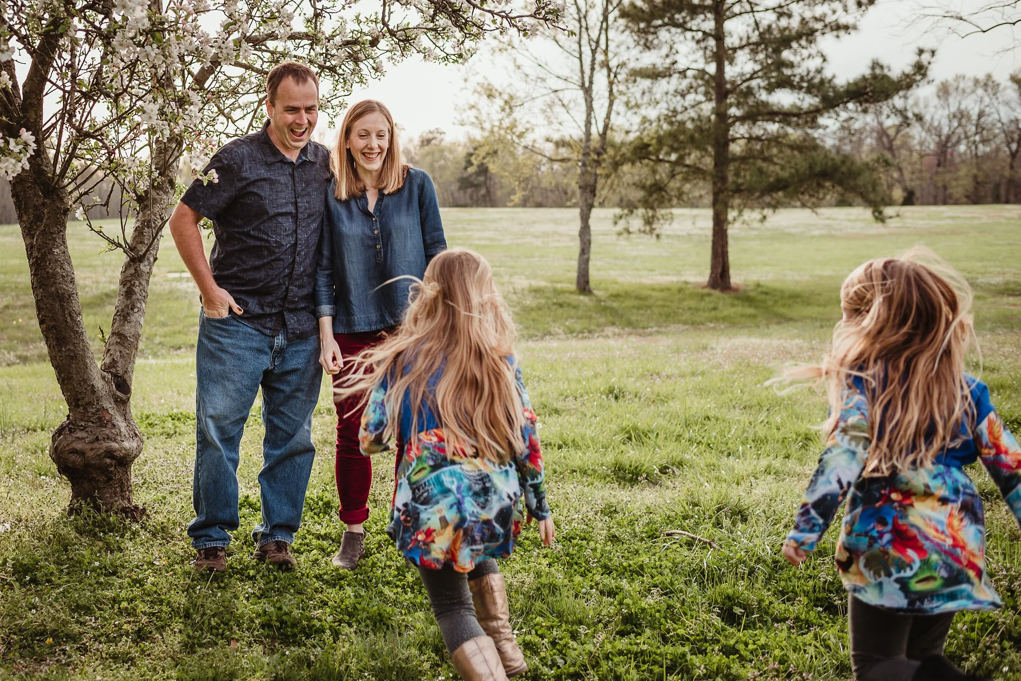 The daughters run to their parents during their family photo session with Rose Trail Images in Wake Forest, North Carolina.
