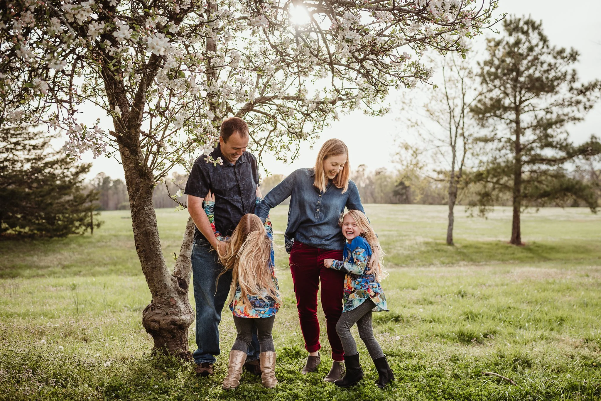 The daughters run and hug their parents during their family photo session with Rose Trail Images in Wake Forest, North Carolina.