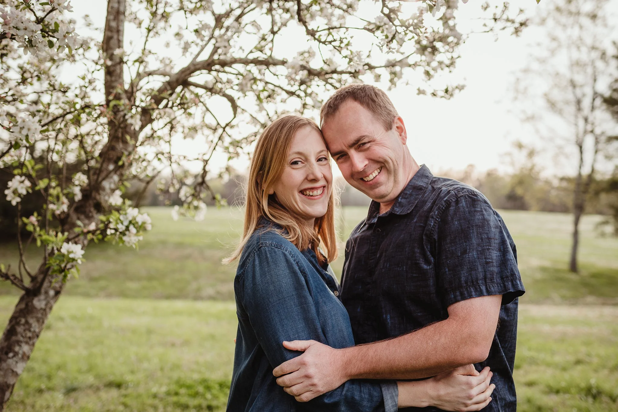 Mom and Dad smile for the camera during their family photo session with Rose Trail Images in Wake Forest, North Carolina.