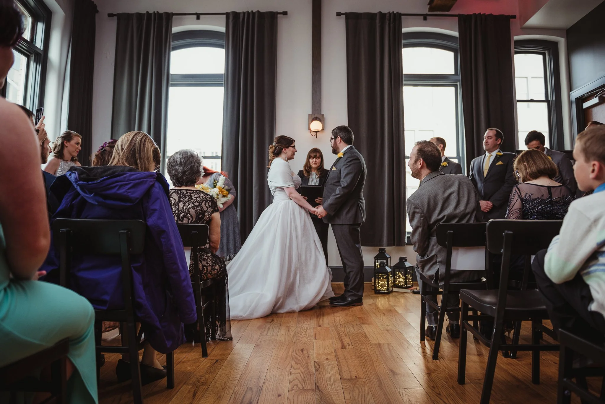 The bride and groom at their wedding ceremony at The Bridge Club in Raleigh, NC, picture by Rose Trail Images.