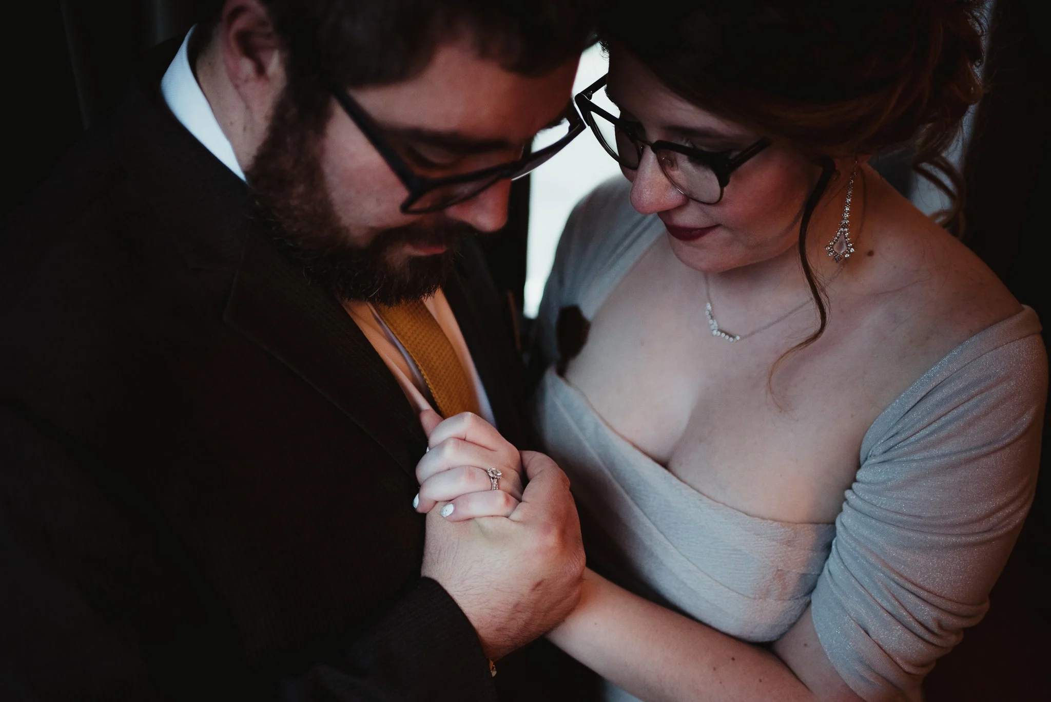 The bride and groom take a moment to hold hands and reflect after their wedding reception in Raleigh, NC, picture by Rose Trail Images.