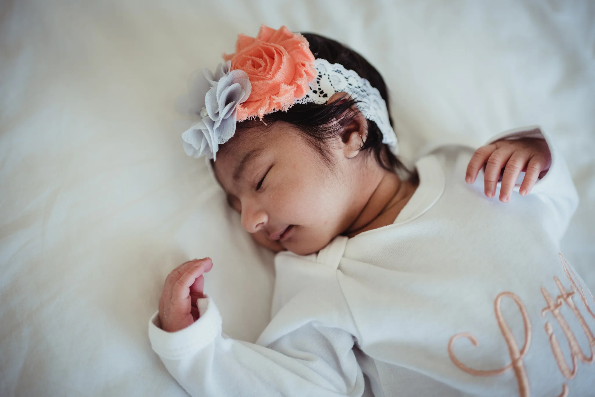 The newborn baby girl sleeps during her lifestyle newborn session with Rose Trail Images in Raleigh, North Carolina. 