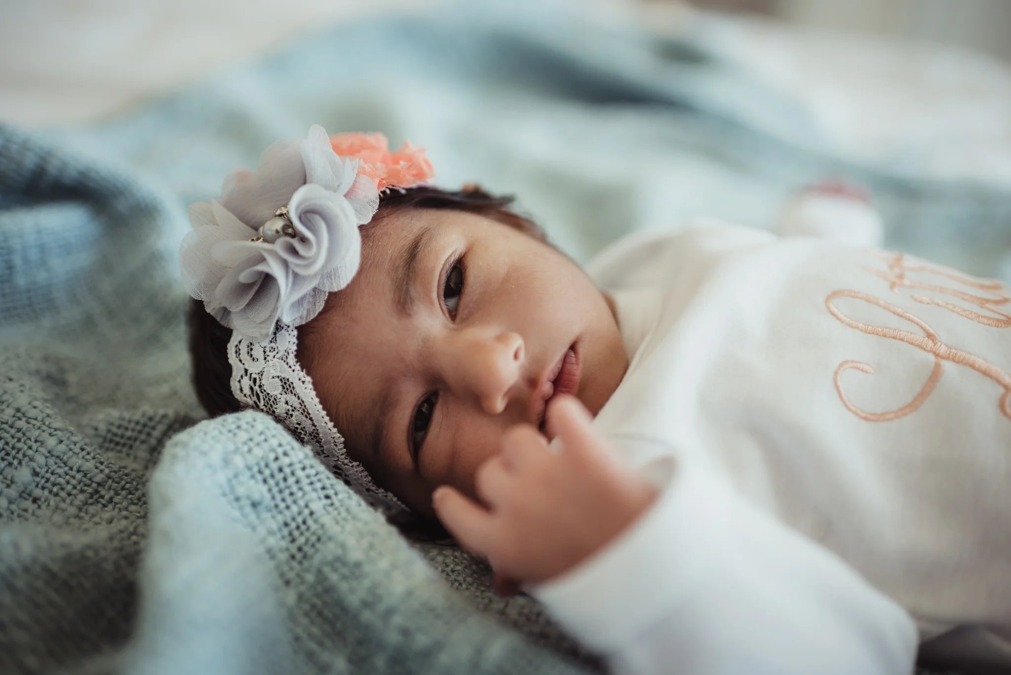 The newborn baby girl opened her eyes during her lifestyle newborn session with Rose Trail Images in Raleigh, North Carolina. 