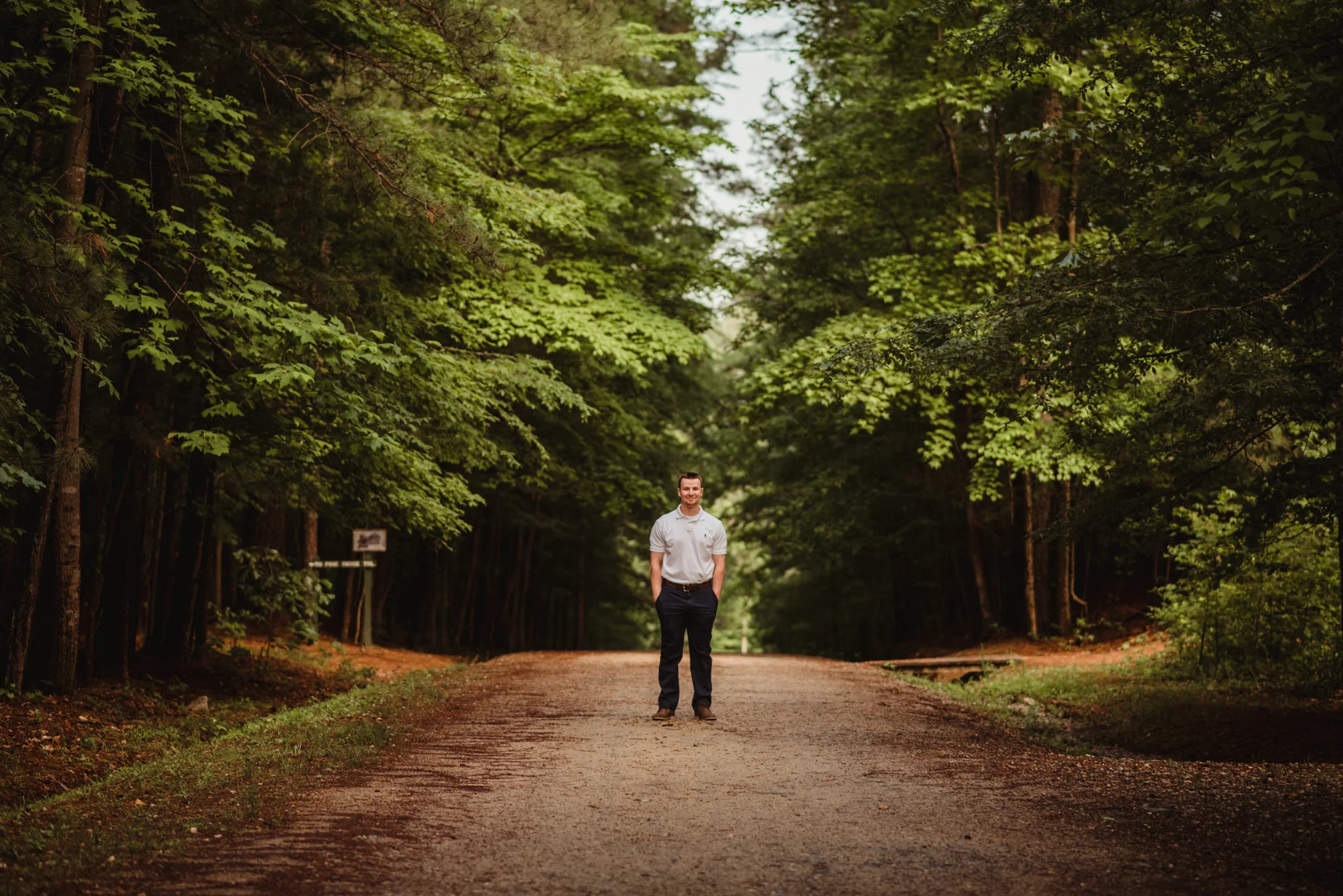 Harrison, walking down the dirt path, had his senior portraits done at Durant Nature Preserve in Raleigh, NC by Rose Trail Images.