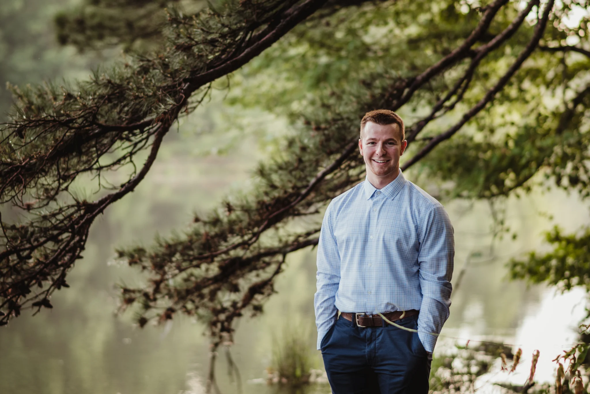 Harrison smiled for Rose Trail Images during his senior portraits in the woods at Durant Nature Preserve in Raleigh, NC.