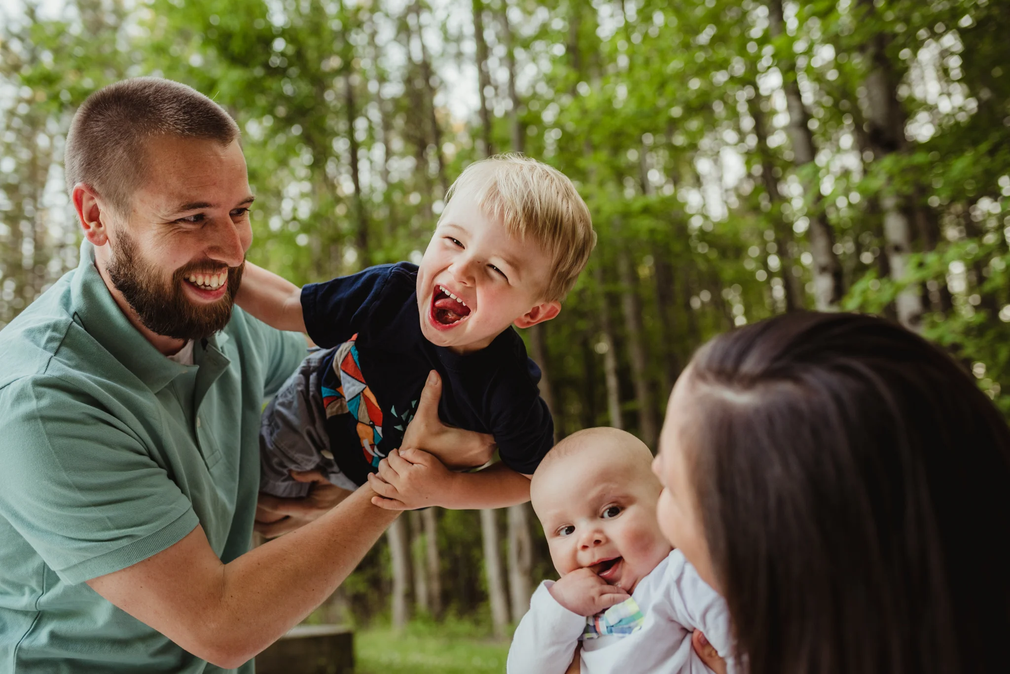 This family of four laughs during their photo session with Rose Trail Images in Rolesville, North Carolina.