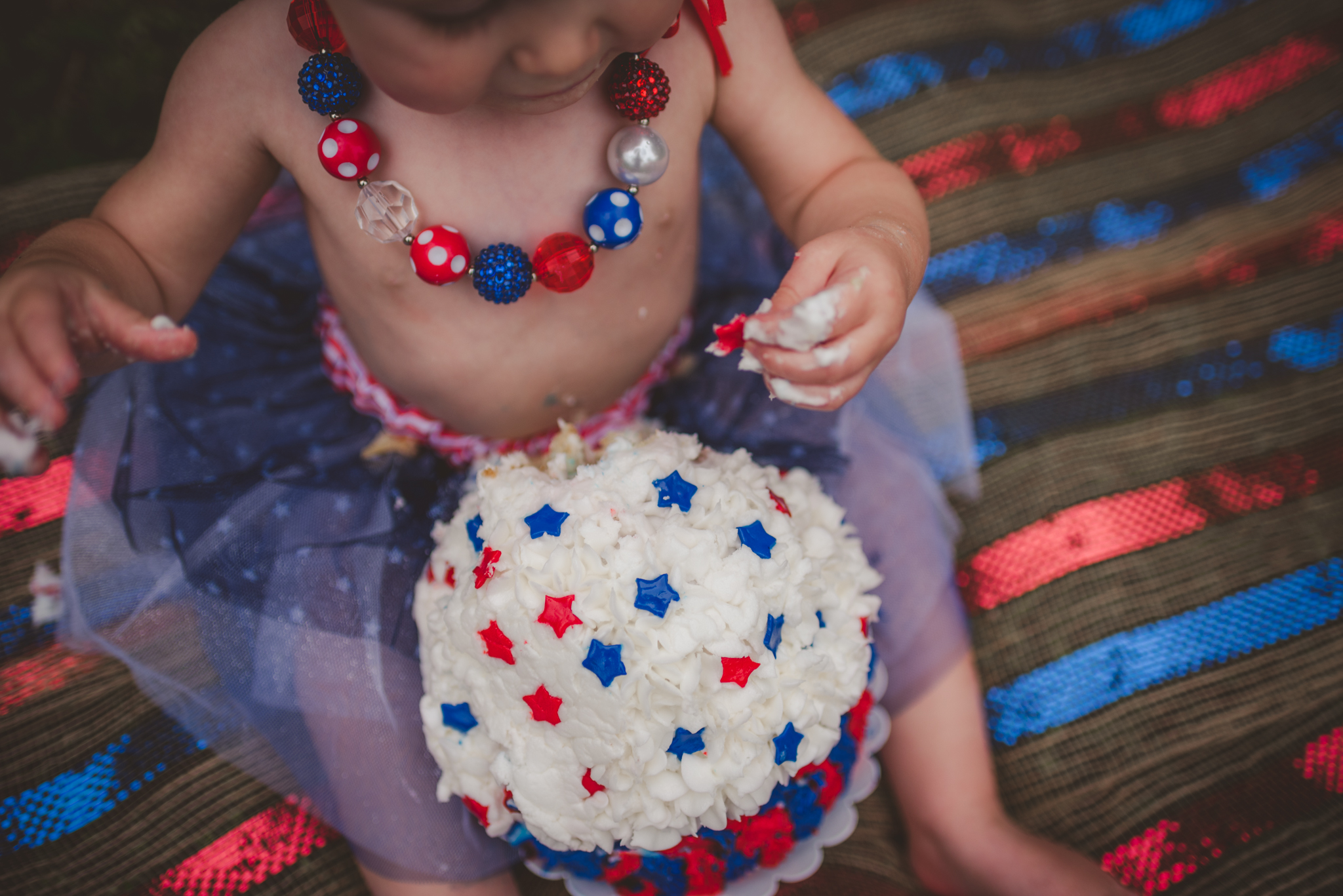 A red, white, and blue firework cake smash for a 4th of July baby