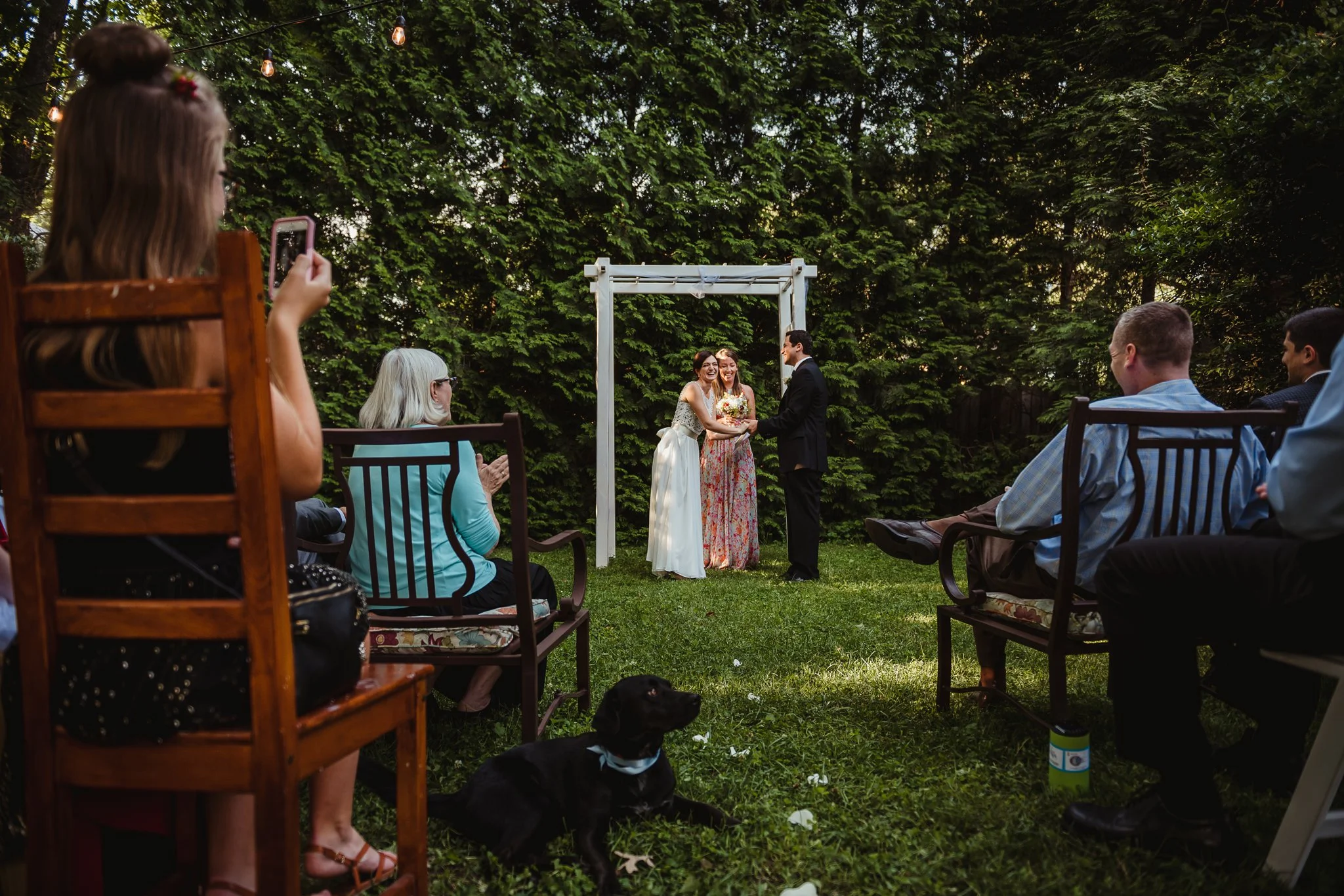 The bride and groom said "I do" during their intimate wedding ceremony that took place in their backyard in downtown Raleigh, North Carolina, photo by Rose Trail Images. 