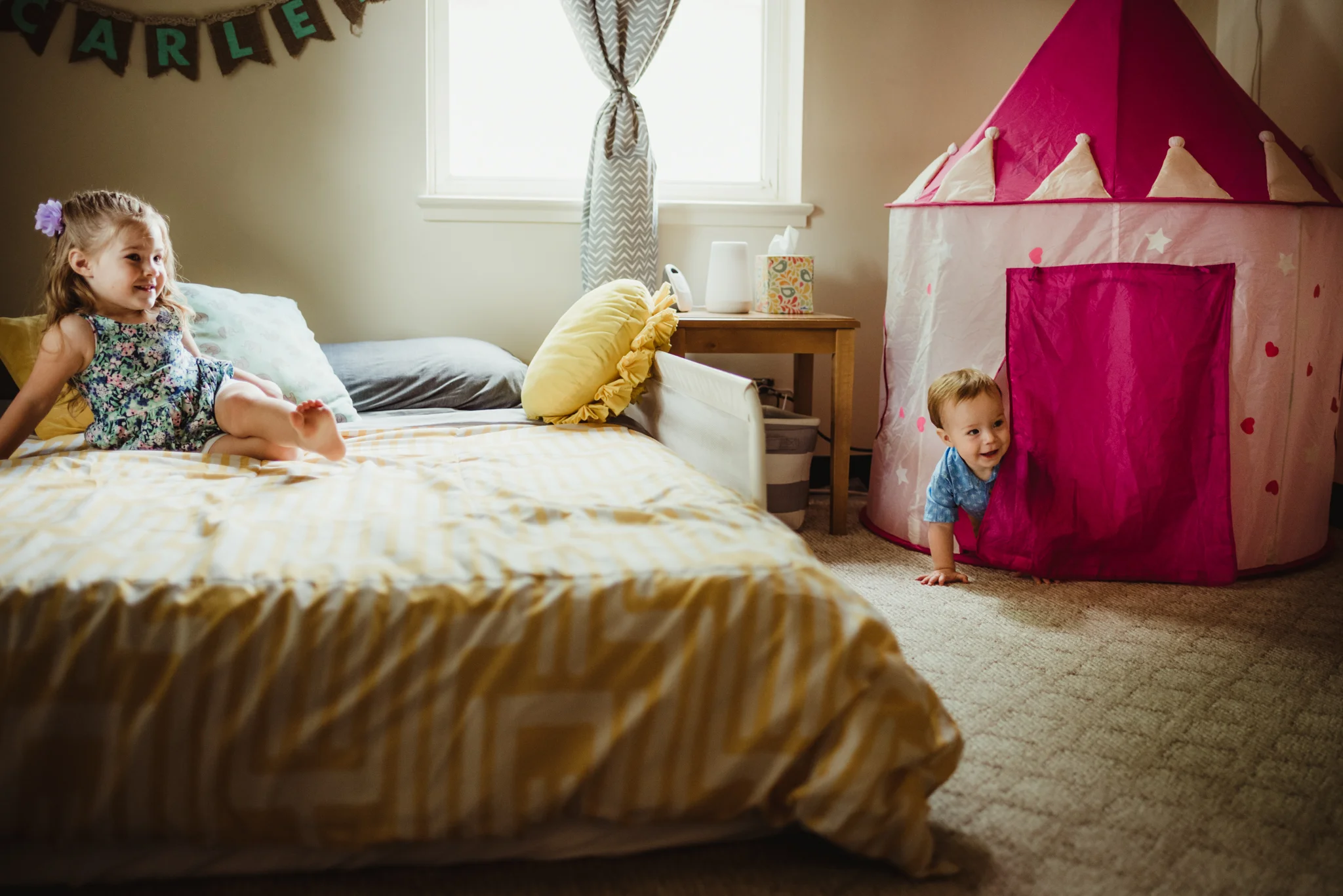 The kids play in the little girl's bedroom during their lifestyle session at home in Wake Forest with Rose Trail Images.