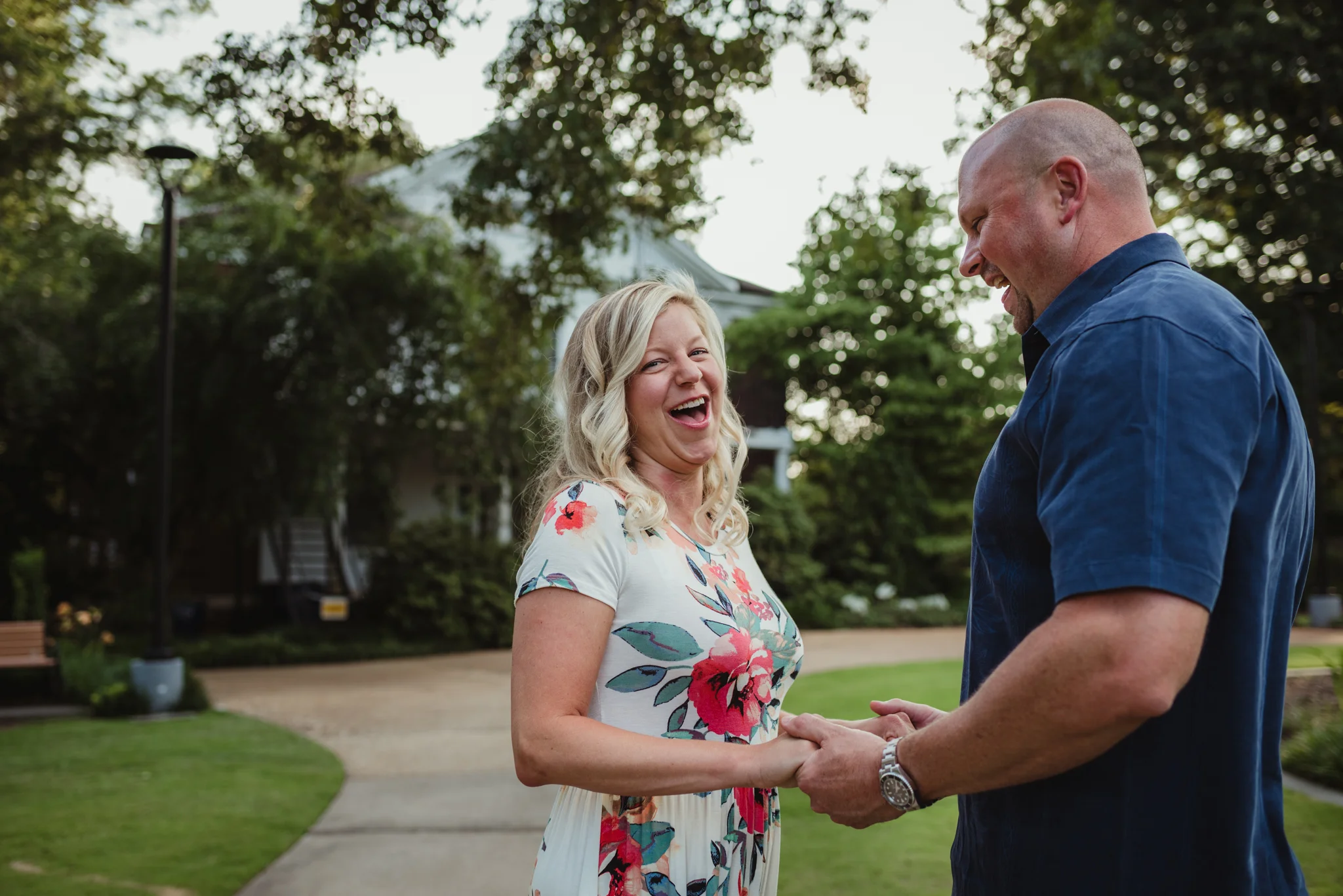 The couple laugh together during their engagement session with Rose Trail Images at Fred Fletcher Park in Raleigh, North Carolina.