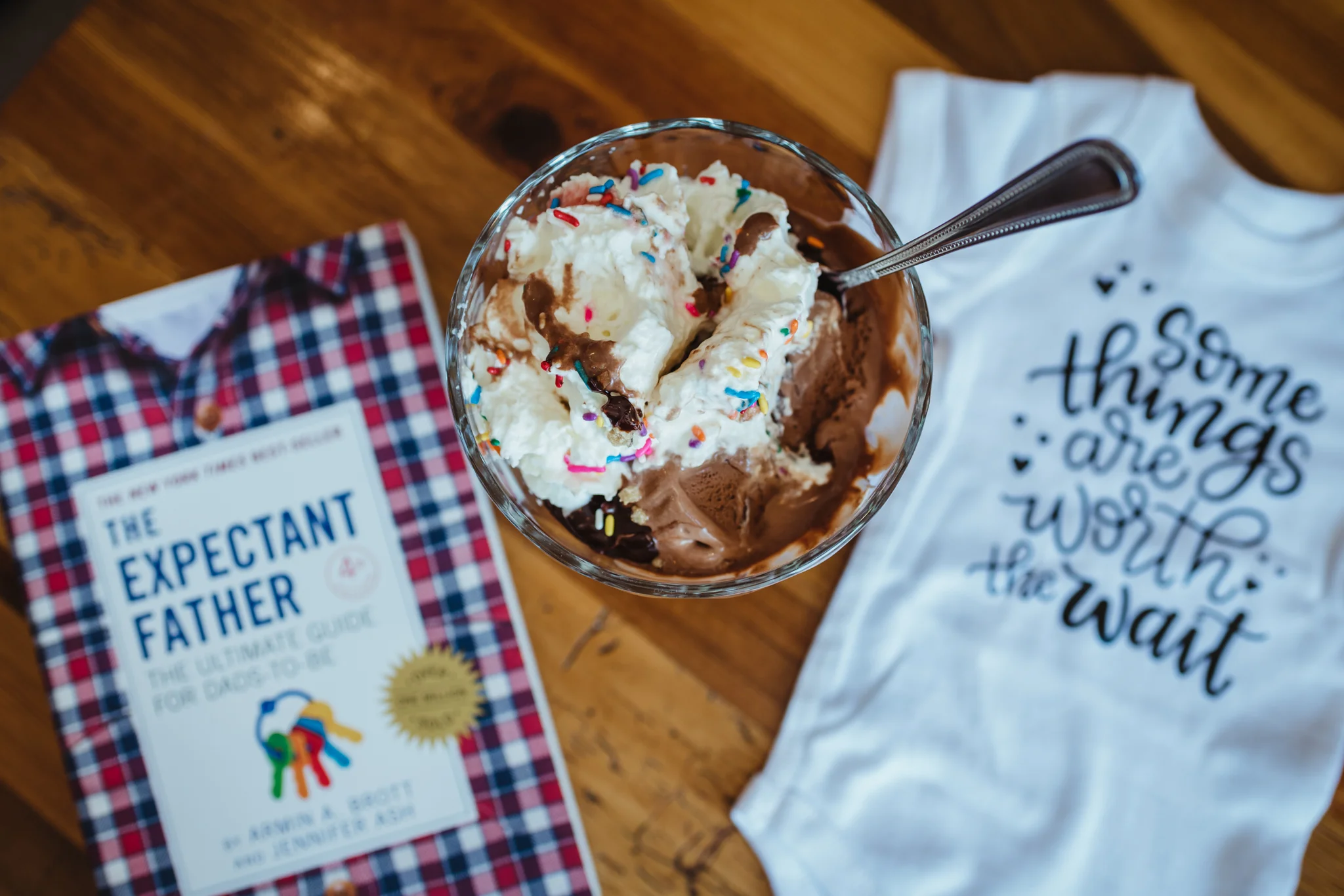 Details of an ice cream sundae, a onesie, and the expectant father book, image by Rose Trail Images.