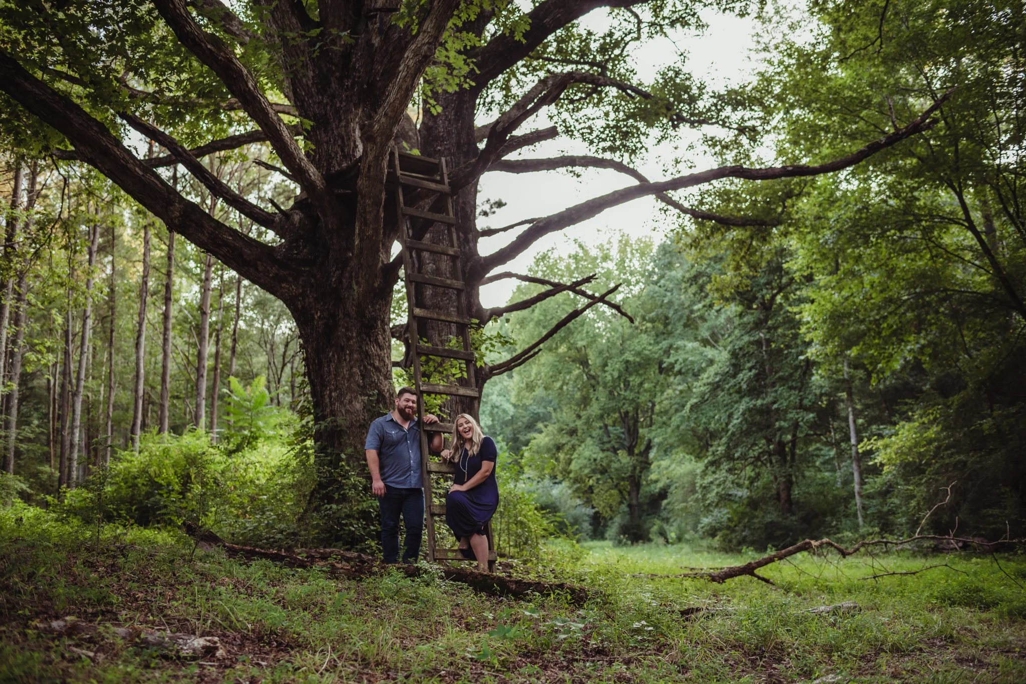 The future bride and groom strike a pose in the woods at the Warren Estate for their engagement pictures with Rose Trail Images.