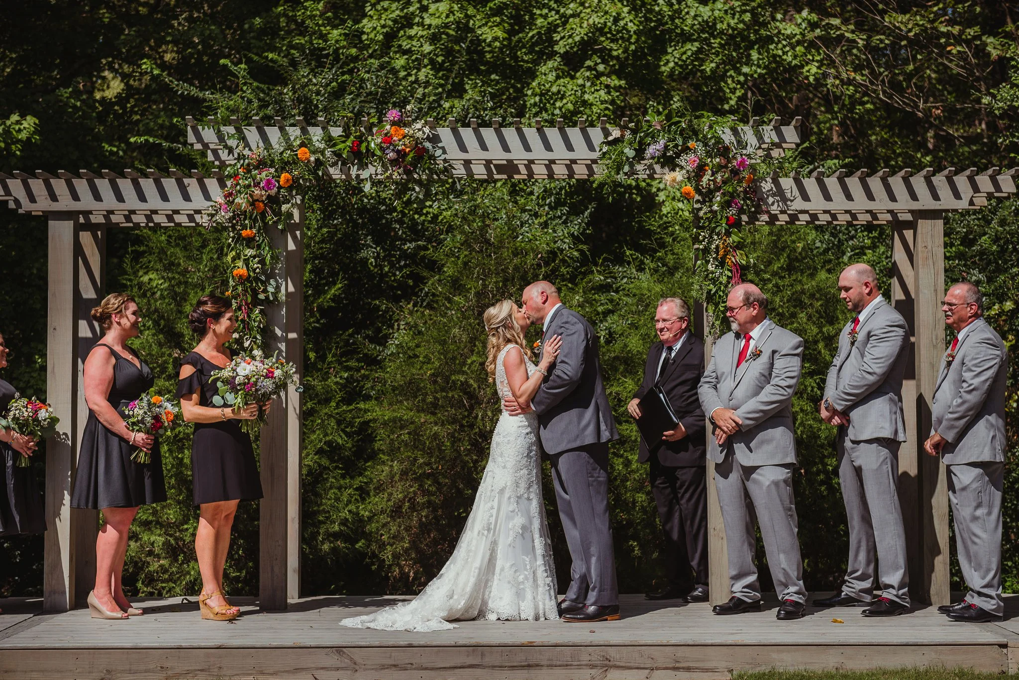 The bride and groom share their first kiss during their wedding ceremony at Cedar Grove Acres near North Carolina, picture from Rose Trail Images.