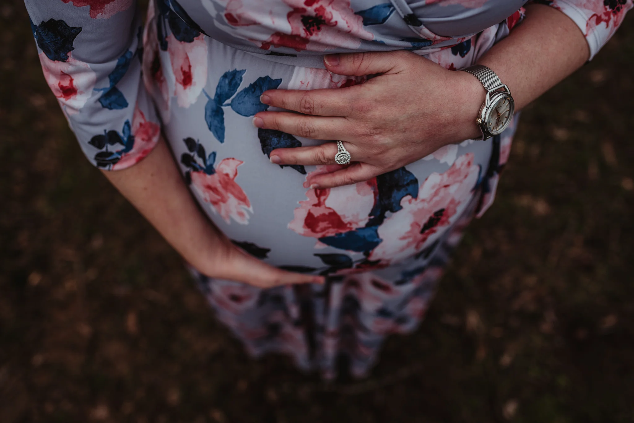 The Mama to be holds her baby bump while waiting for baby girl to arrive, picture taken by Rose Trail Images at Joyner Park in Wake Forest, NC.