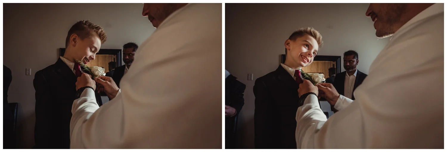 The groom pinned on a boutonniere for his son before his wedding ceremony at All Saints Chapel in Raleigh, North Carolina, pictures by Rose Trail Images.