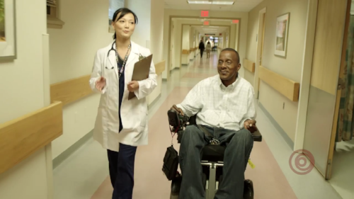 Doctor and patient talking in hospital hallway
