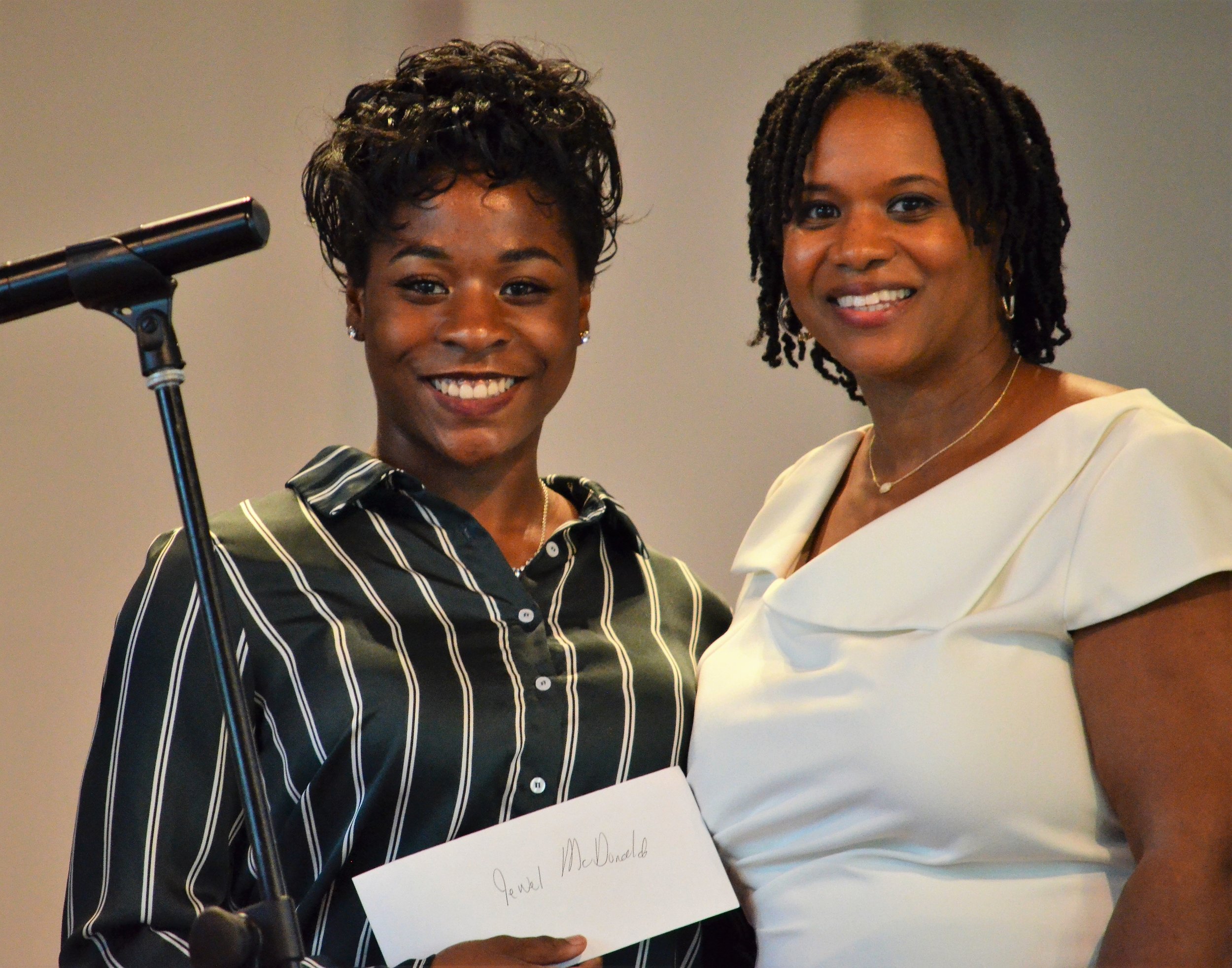  Jewel McDonald accepts the Dr. Jowava Morrow Book Scholarship Award from Yaminah Leggett-Wells, daughter and family representative of Dr. Jowava Morrow. Jewel is attending North Carolina A&amp;T State University in Greensboro, N.C. 