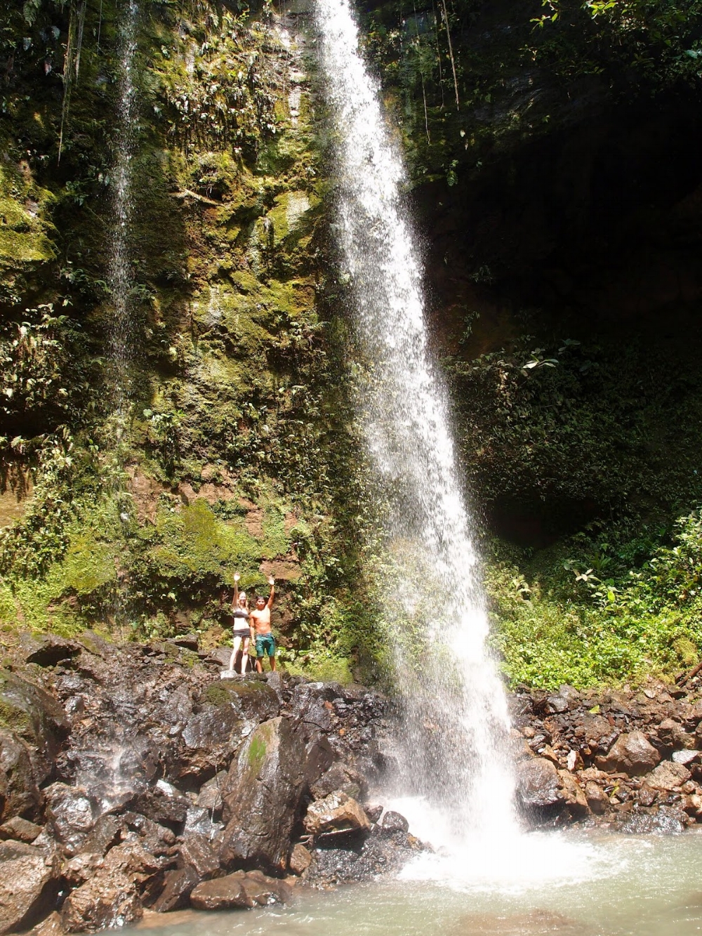 Pegonka and Laura at a sacred waterfall in the remote Huaorani territory of the Ecuadorian Amazon
