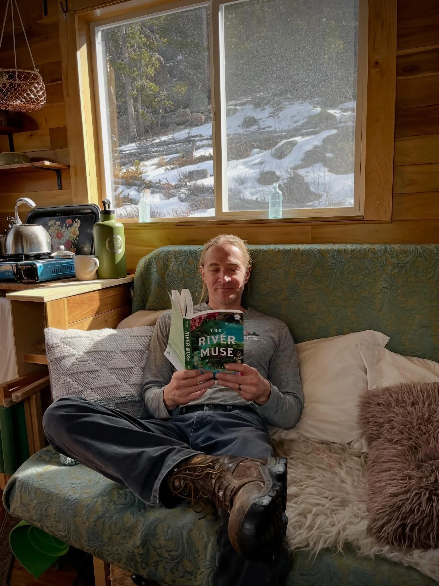 Look what my husband, Ian, is reading at our tiny cabin!🥰 Swipe to see his favorite mountain man activity&hellip; 🏔️... and swipe again to see the composting toilettes he and Bran built me for Mother's Day years ago. If you read The Alchemy of Flow
