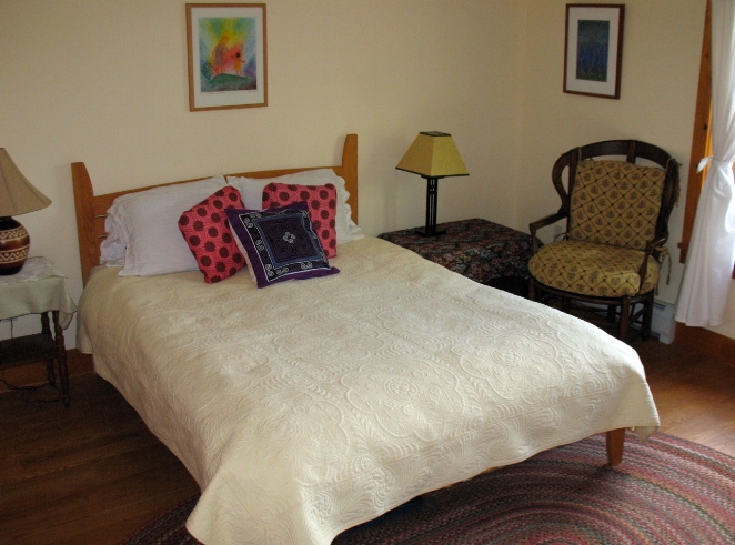 Another view of the Sunset Room, showing the queen bed (this bed frame was hand made using local wood)