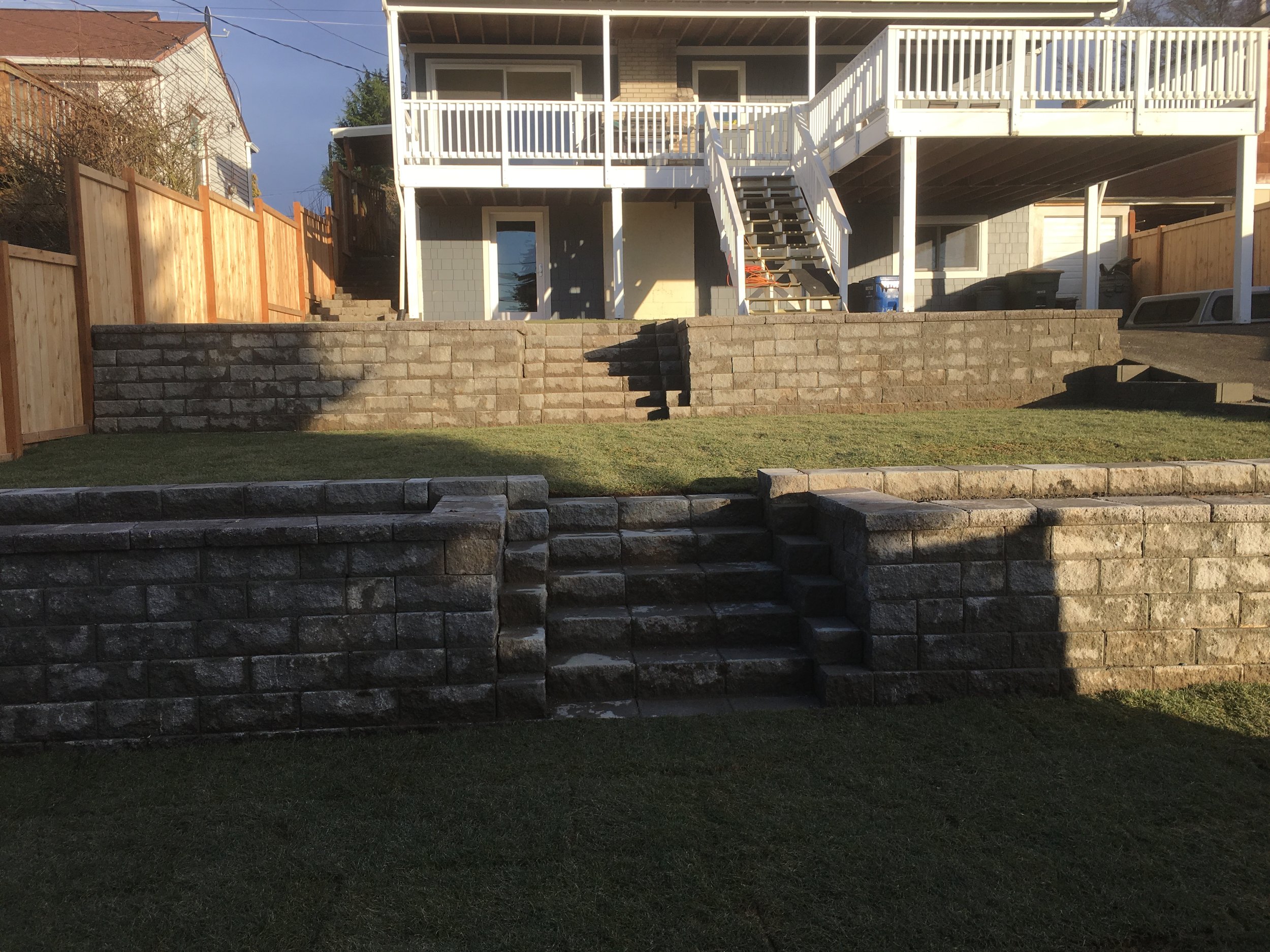 Terraced retaining wall, stairs and new sod