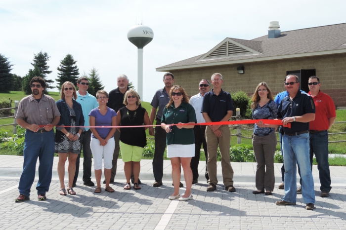 Pictured are some of the participants of the ribbon cutting, including city admininistrator Dan Canton, councilwoman Randee Blietz, watershed planner Ross Evelsizer, deputy clerk Linda Gullickson, Eric Palas with Clayton County SWCD and the Iowa Department of Agriculture and Land Stewardship, swimming pool board member Pam Havlicek, councilman Andrew Meyer, mayor Barb Collins, Tracy Scebold with the Iowa Finance Authority, engineer Jon Biederman, Tiffany Wilson Lillard with the DNR, Corey Bacon of Bacon Concrete (partially hidden), councilman Dan Havlicek and Nick Jensen of Culvers Lawn and Landscape.