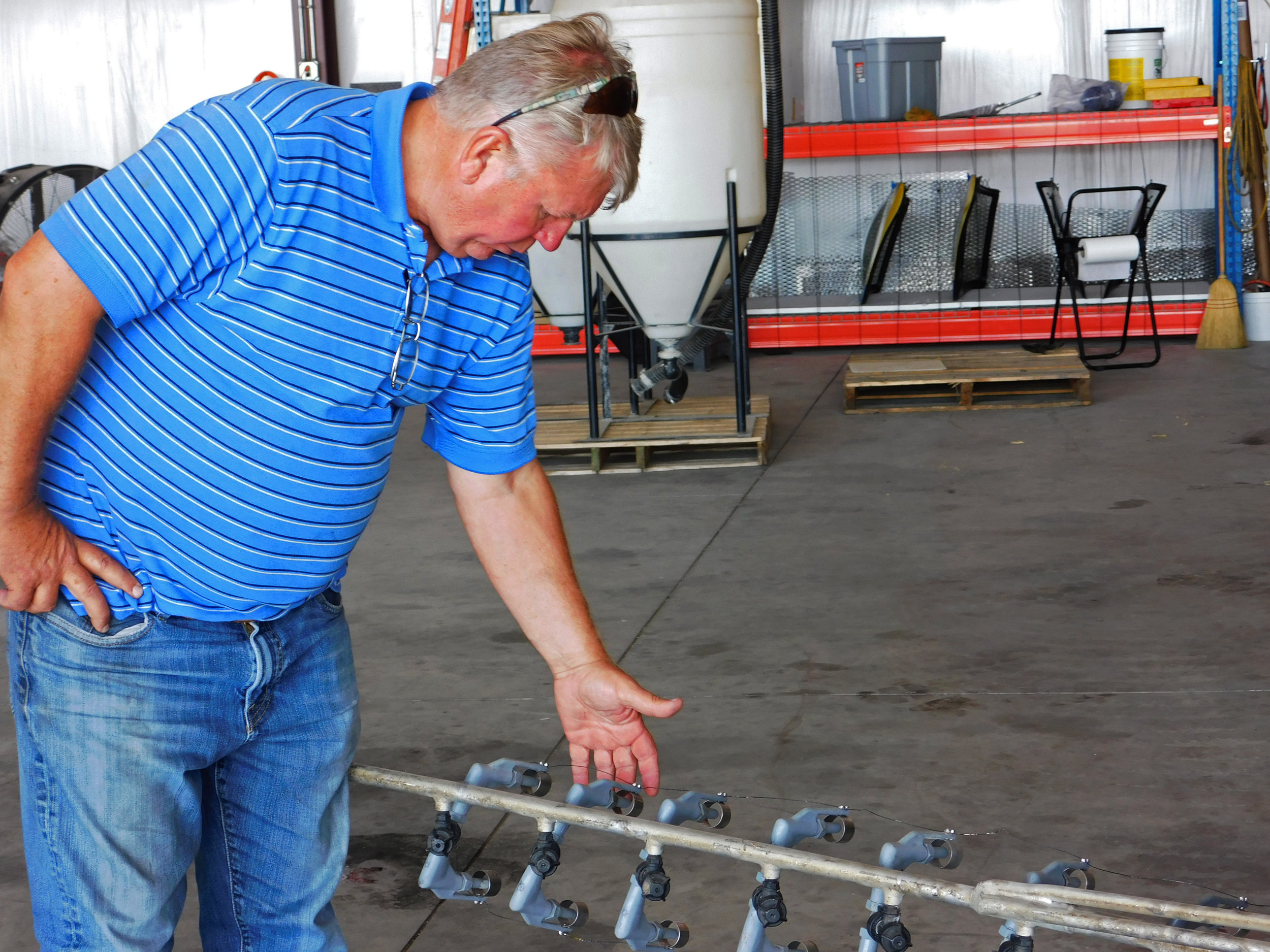   Johnson speaks about his hydrostatic aerial sprayer.  