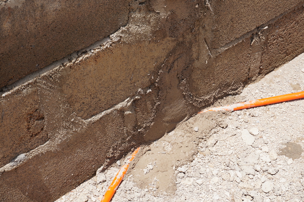 Conduit is ran through a flexible orange hose.