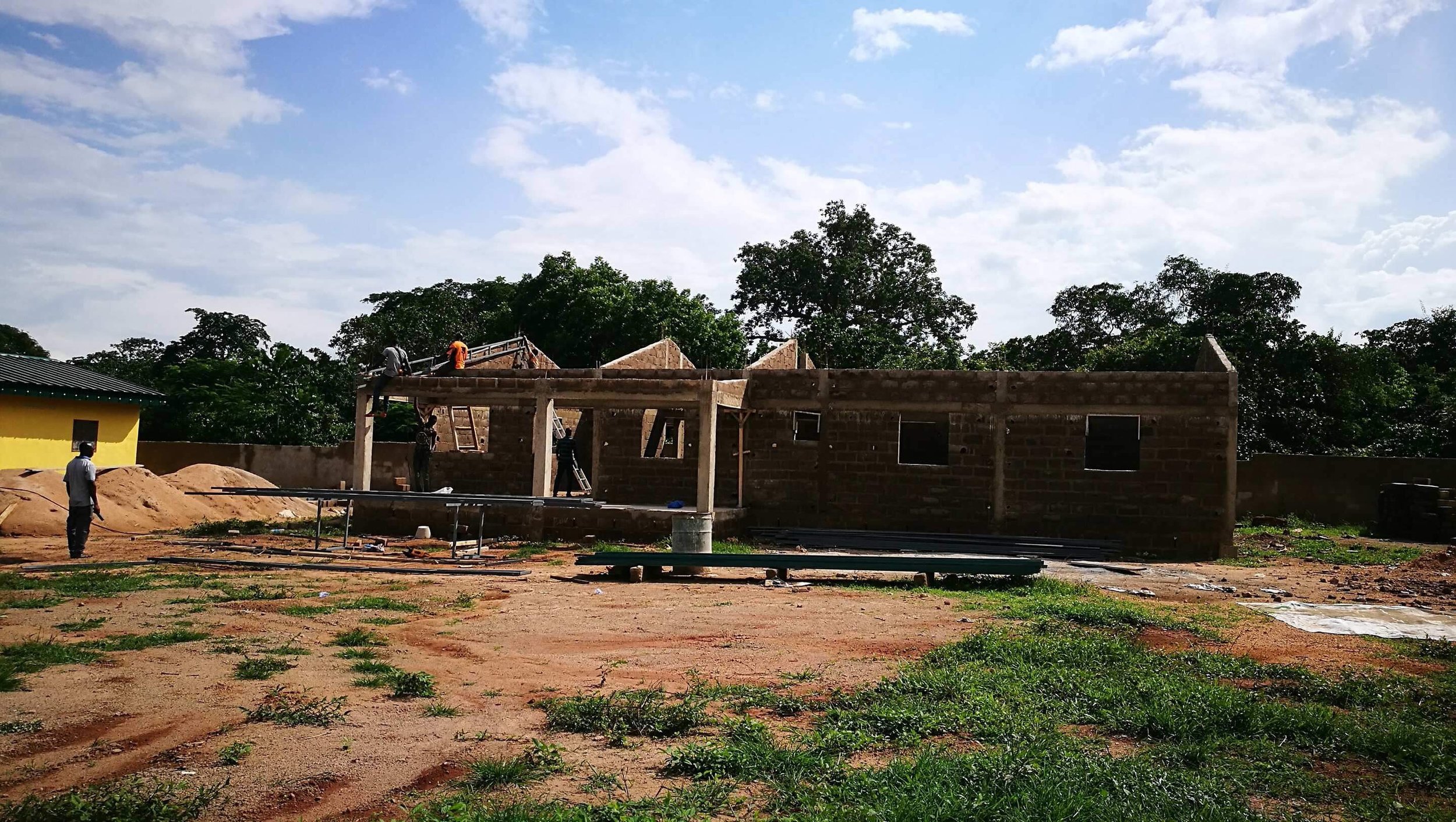Another angle of workers installing trusses.