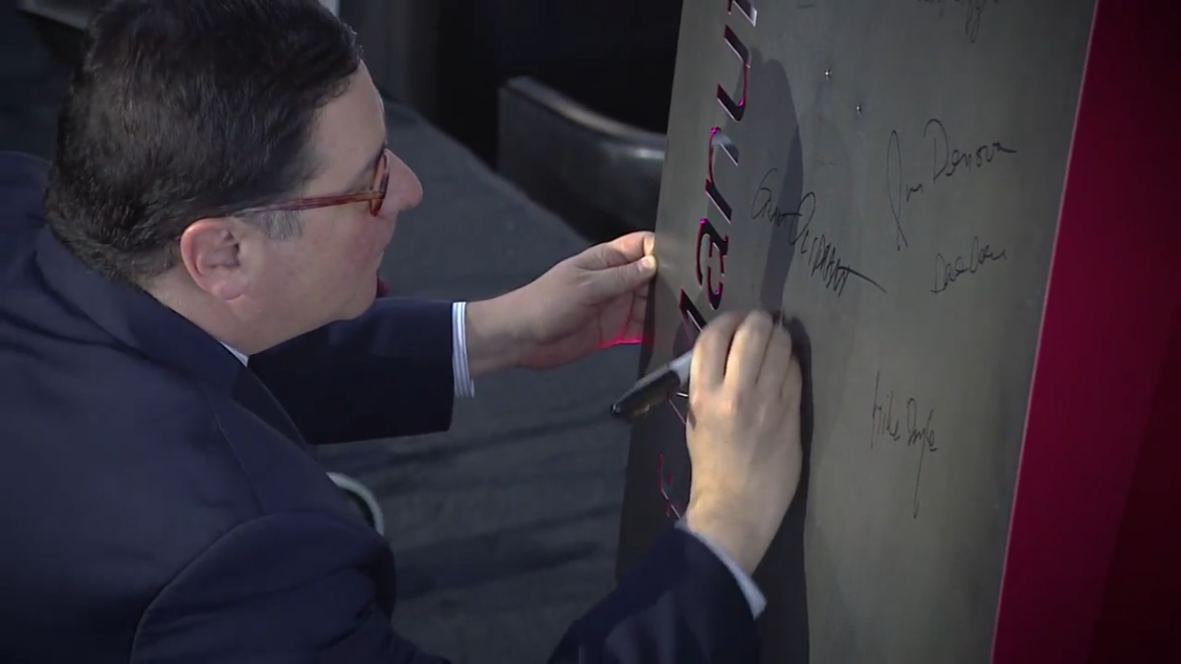 Pittsburgh mayor Bill Peduto signs the steel sculpture