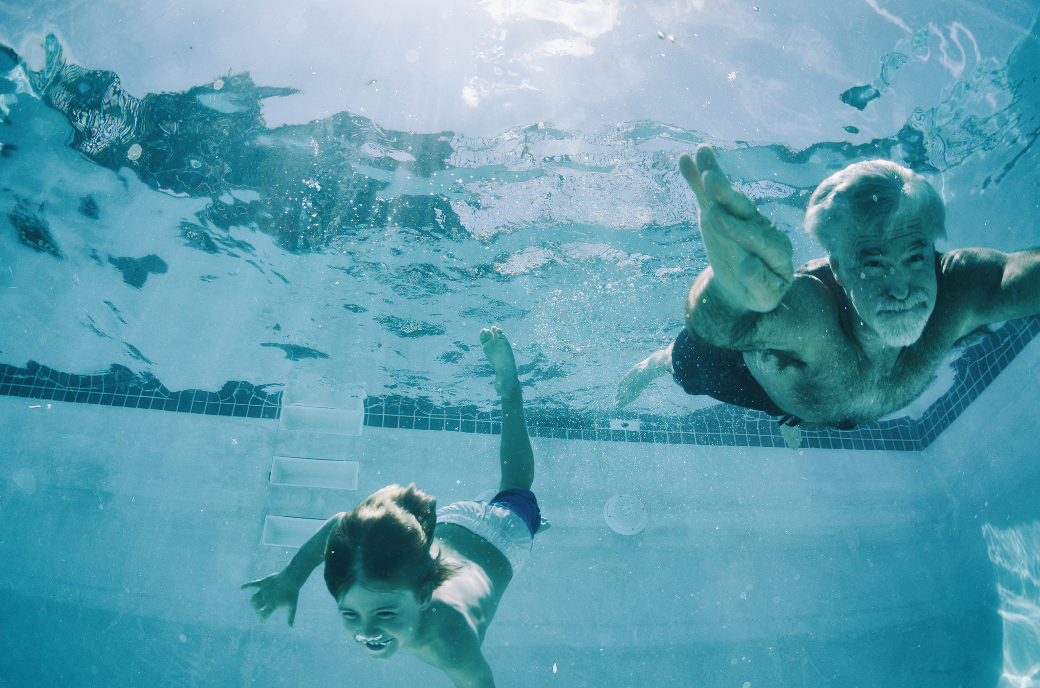 Grandpa-and-Grandson-swimming-underwater-in-summer-510562062_2131x1411.jpeg