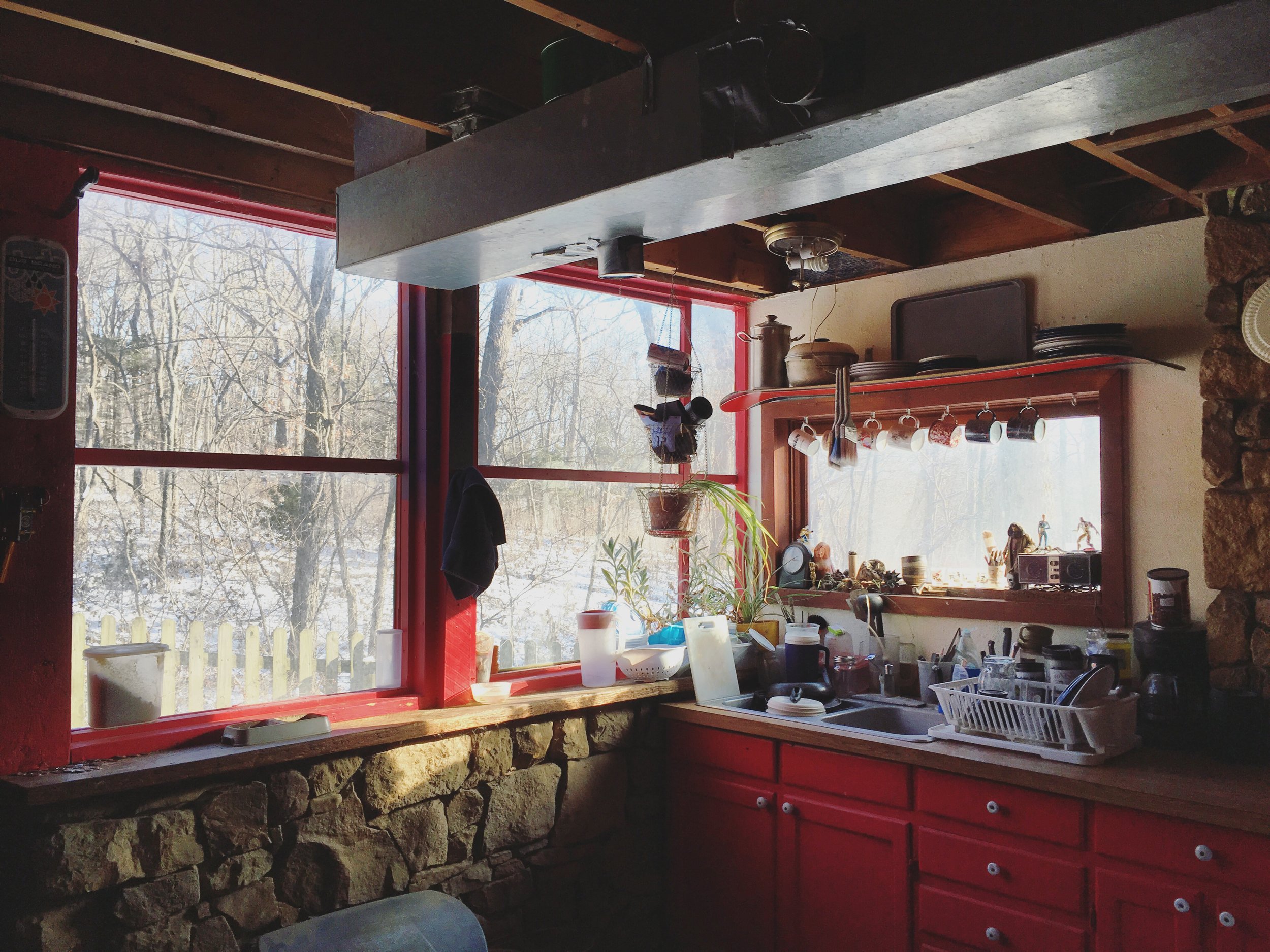 The kitchen is uninsulated, with the limestone structure of the house serving as interior wall. Even in this room, the light is great. The HVAC is exposed, but I kinda dig it. It keeps the space raw. It feels like a space you can really work in, wit…